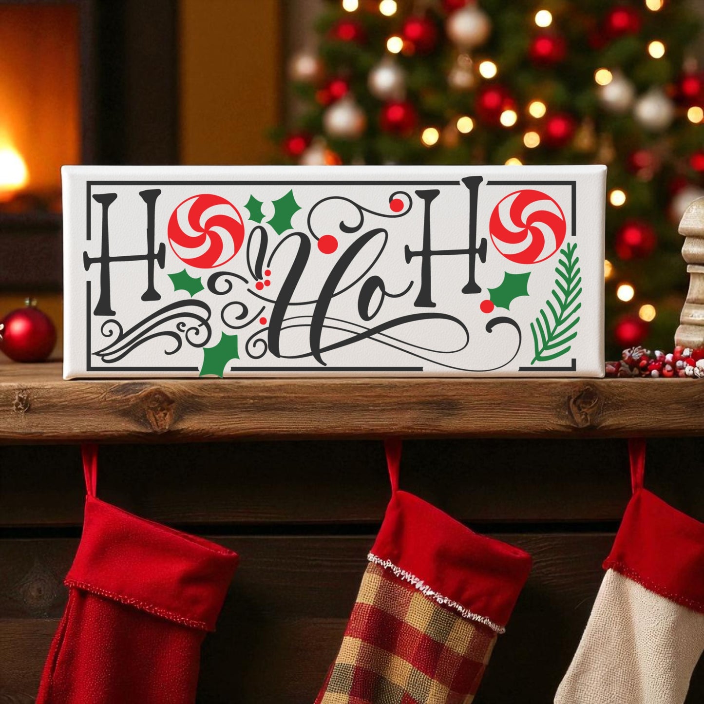 The Ho Ho Ho Shelf Sitter Christmas Sign by Mirabilia Boutique features holly, candy canes, and festive lettering on a mantel above red stockings, surrounded by charming holiday decor and a blurred Christmas tree behind.