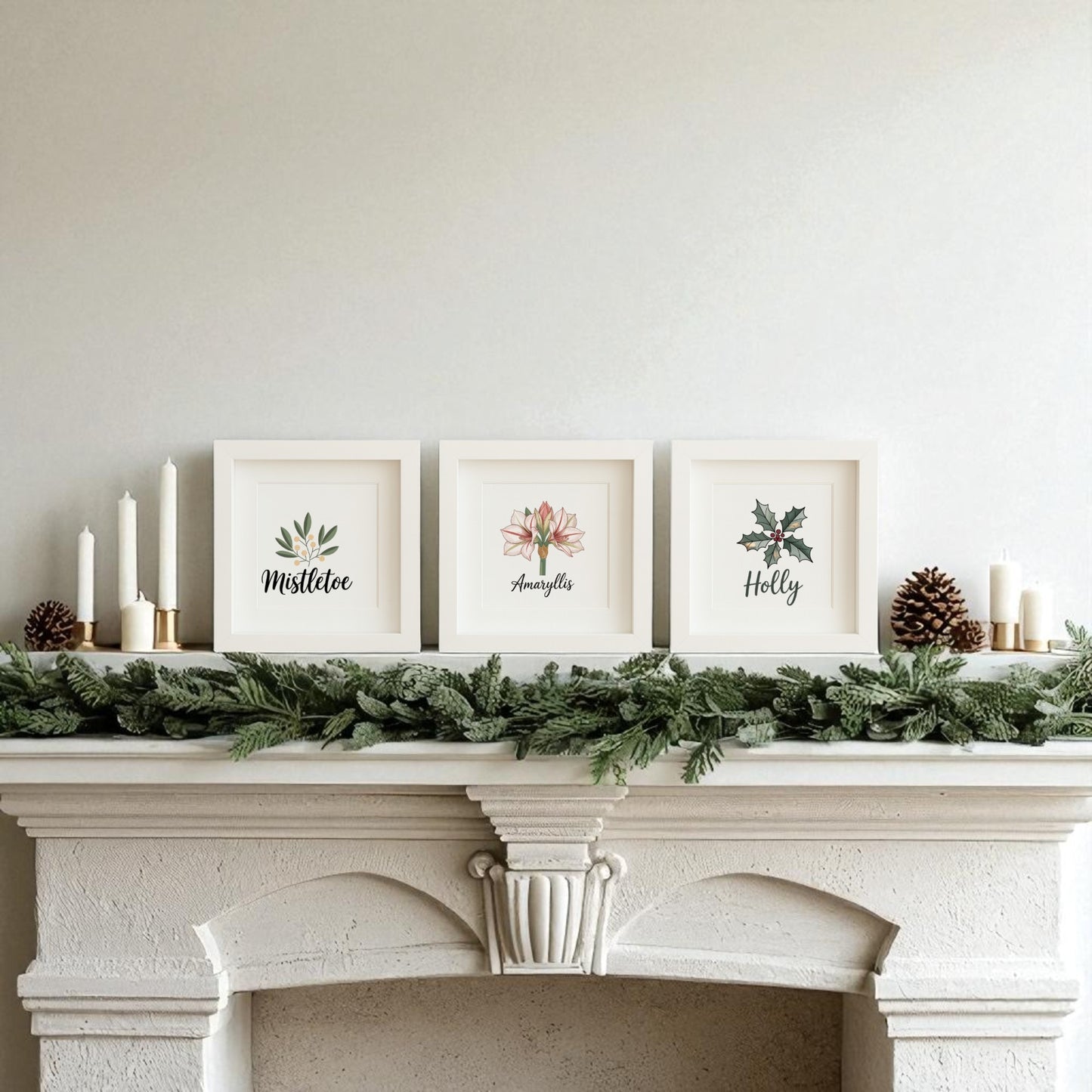 A white mantel decorated with pine garland, candles, and Mirabilia Boutique’s Mistletoe Amaryllis Holly Prints | Holiday Shadowbox Trio adds charming botanical holiday flair to a light-colored wall.