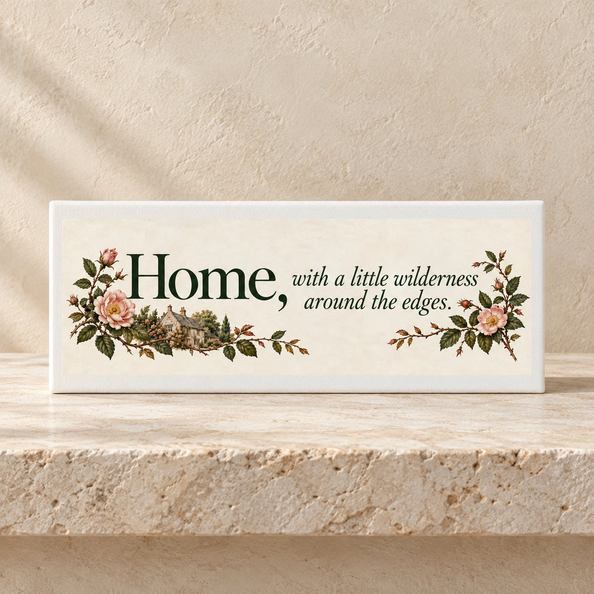 Home & Wilderness Canvas Shelf Sitter rectangular sign reading, “Home, with a little wilderness around the edges,” decorated with illustrations of an English stone cottage, roses, and greenery.