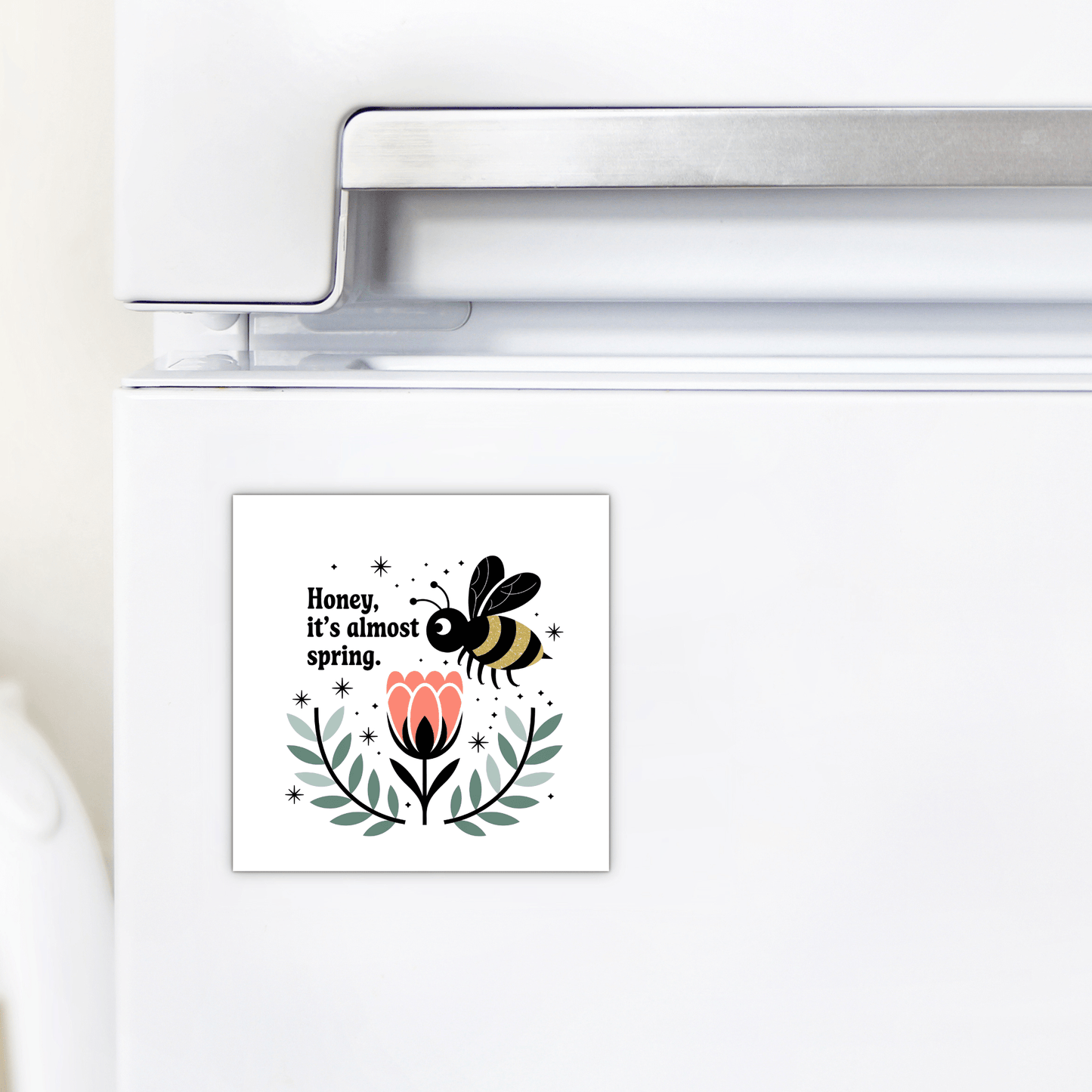 The Honey It’s Almost Spring Magnet by Mirabilia Boutique is a cute bee fridge magnet featuring a bee over a pink flower and the text "Honey, it’s almost spring"—a colorful, charming addition to your kitchen decor.