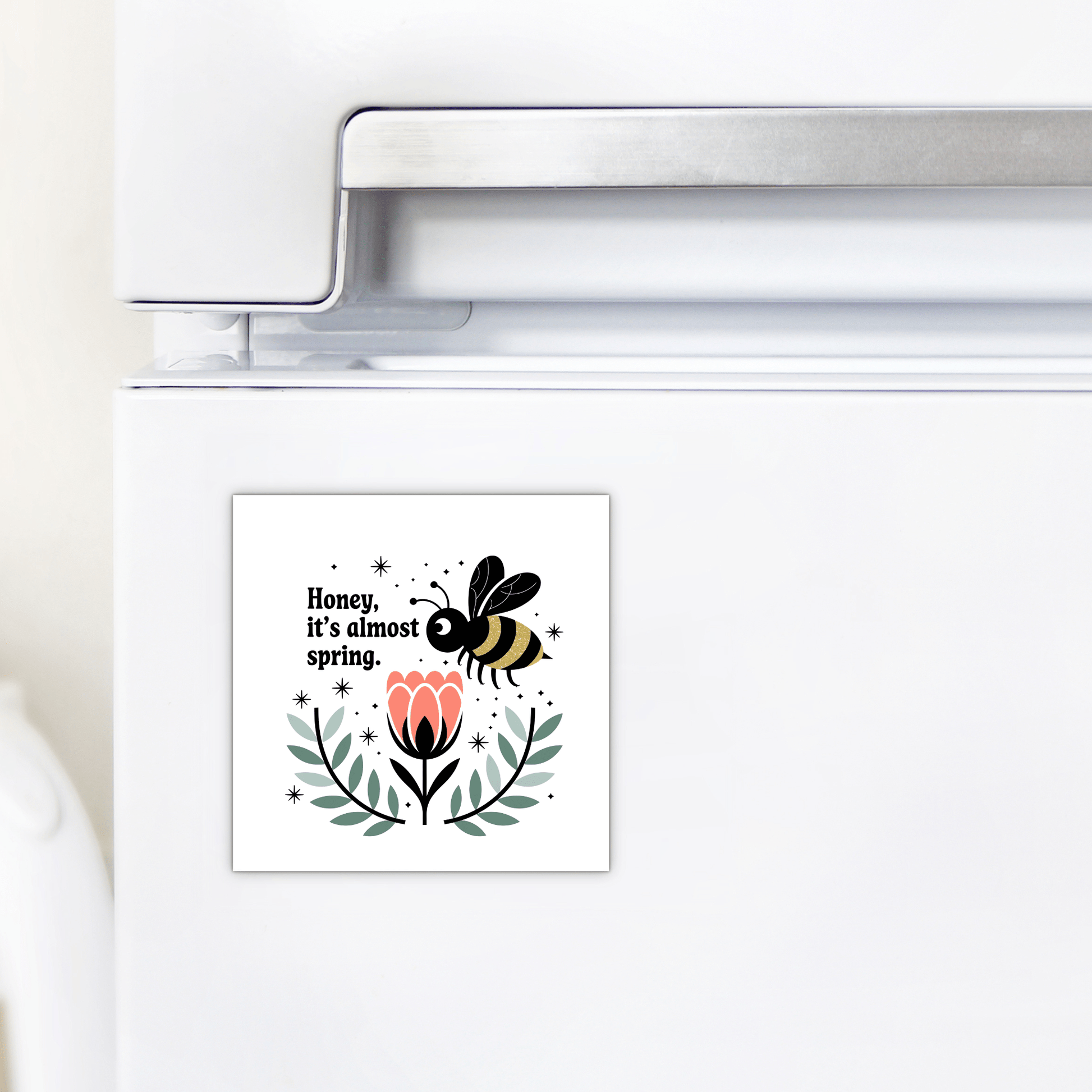 The Honey It’s Almost Spring Magnet by Mirabilia Boutique is a cute bee fridge magnet featuring a bee over a pink flower and the text "Honey, it’s almost spring"—a colorful, charming addition to your kitchen decor.