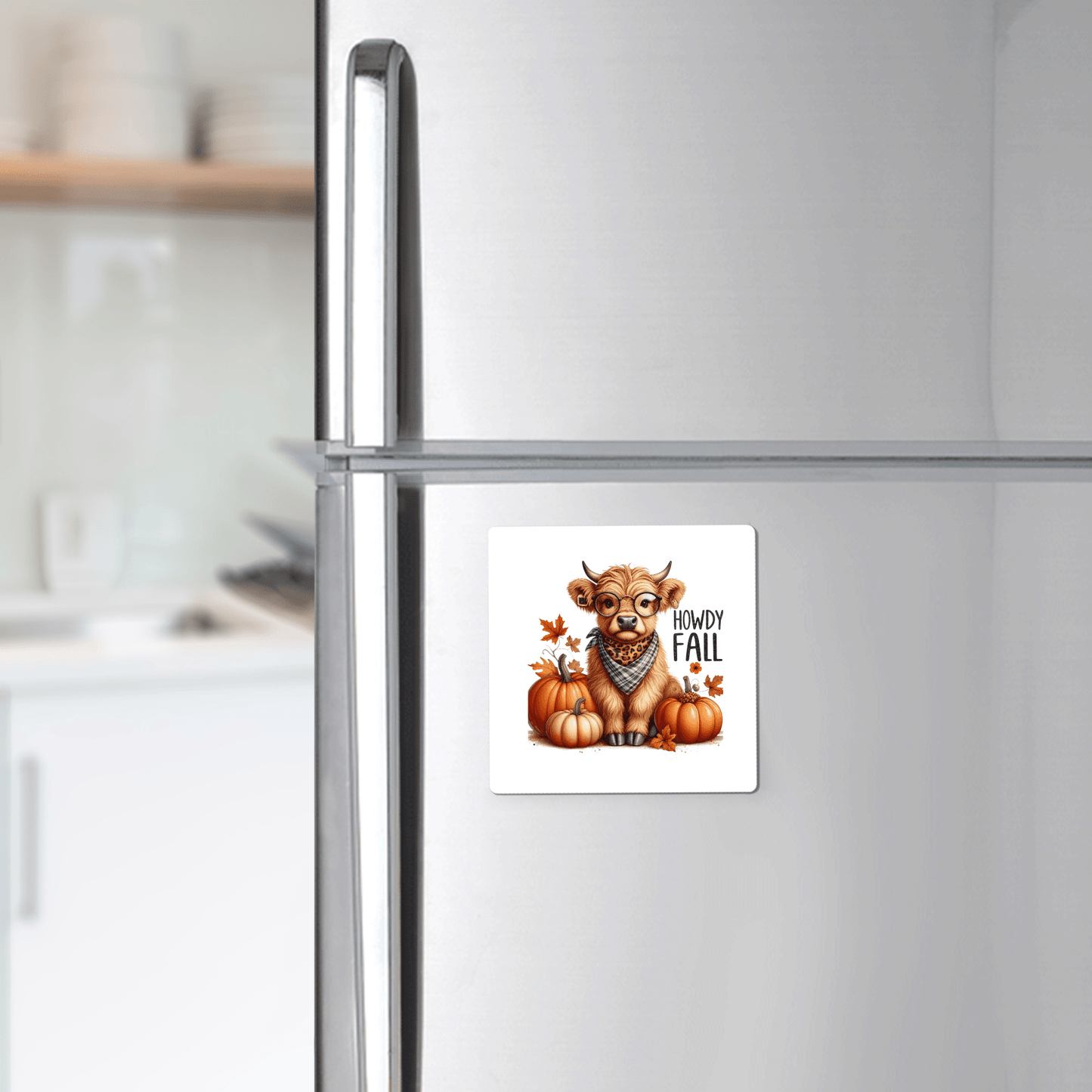 A farmhouse kitchen showcases the Mirabilia Boutique Howdy Fall Highland Cow Magnet—featuring a cute cow with a scarf, pumpkins, leaves, and “Howdy Fall” text—for charming autumn decor.