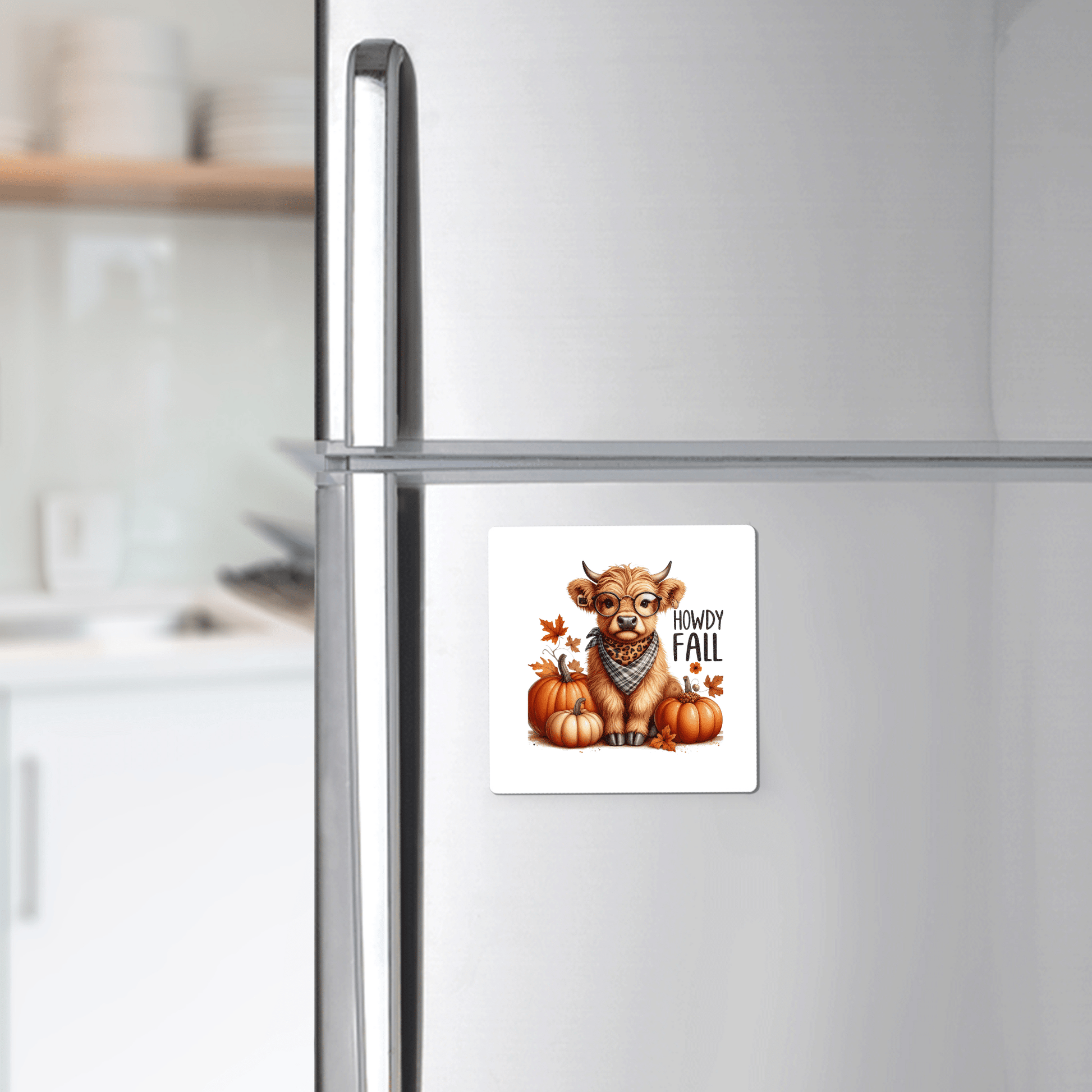 A farmhouse kitchen showcases the Mirabilia Boutique Howdy Fall Highland Cow Magnet—featuring a cute cow with a scarf, pumpkins, leaves, and “Howdy Fall” text—for charming autumn decor.