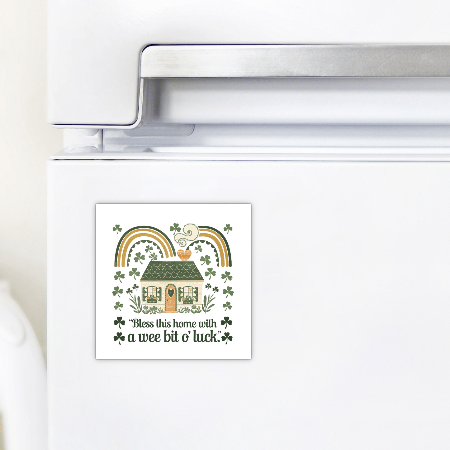 The Wee Bit o’ Luck Irish Home Magnet by Mirabilia Boutique adds festive Celtic charm to your fridge, featuring a house, rainbows, shamrocks, and "Bless this home with a wee bit o' luck" in green and gold. Perfect for St. Patrick's Day decor!.