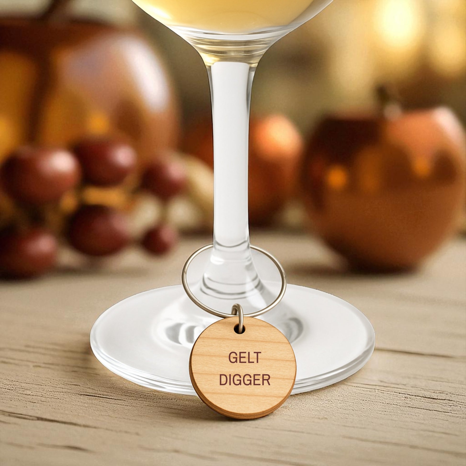 Mirabilia Boutique’s Jewish Wine Charms—Hanukkah Wine Glass Markers Set of 8—feature playful engraved wooden charms like "GELT DIGGER." Perfect for unique Jewish holiday gifts, these add festive flair to any wine glass.