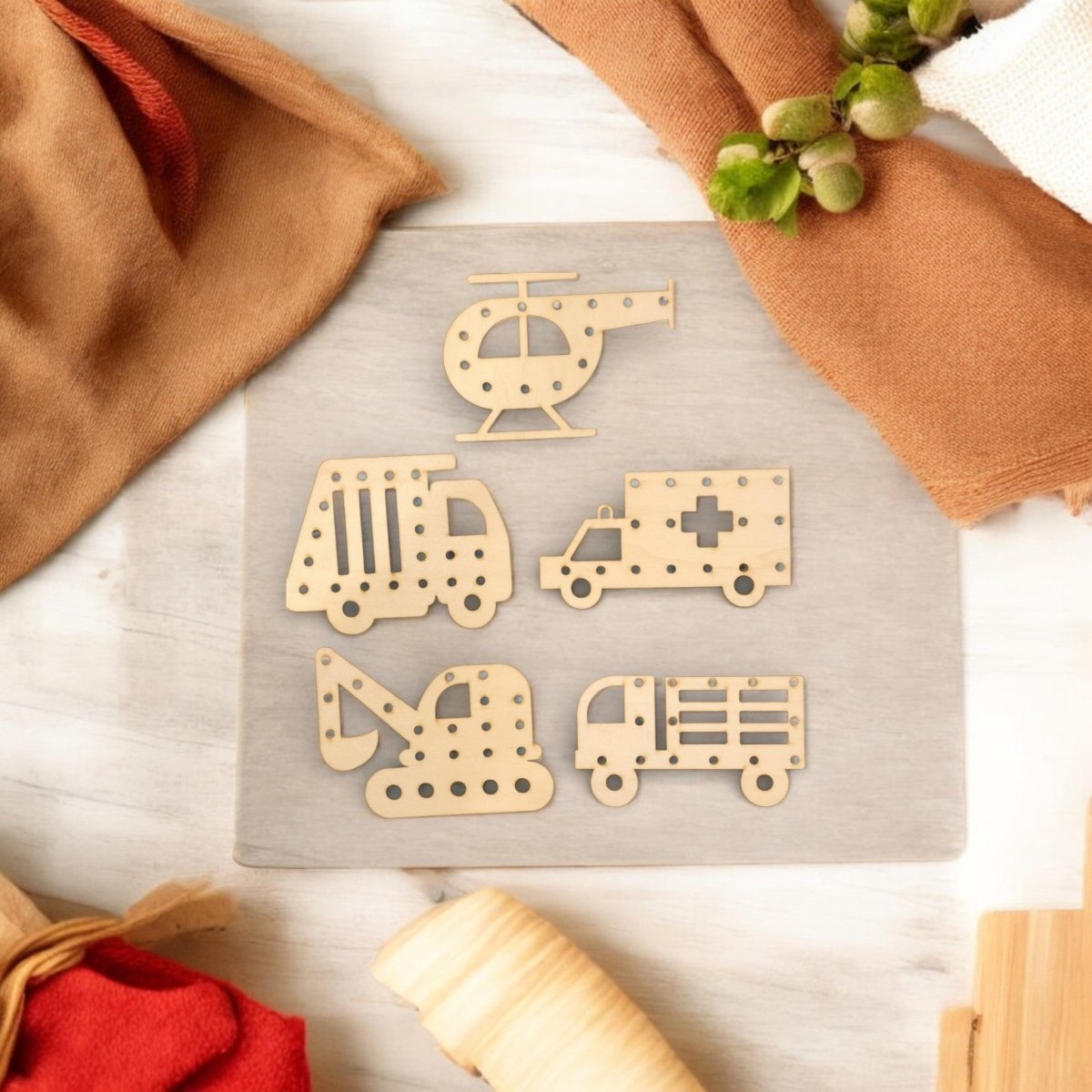 Mirabilia Boutique’s Vehicle Lacing Trays for Fine Motor Skills, featuring a helicopter, garbage truck, ambulance, excavator, and fire truck, are ideal for preschool learning and enhancing hand-eye coordination.