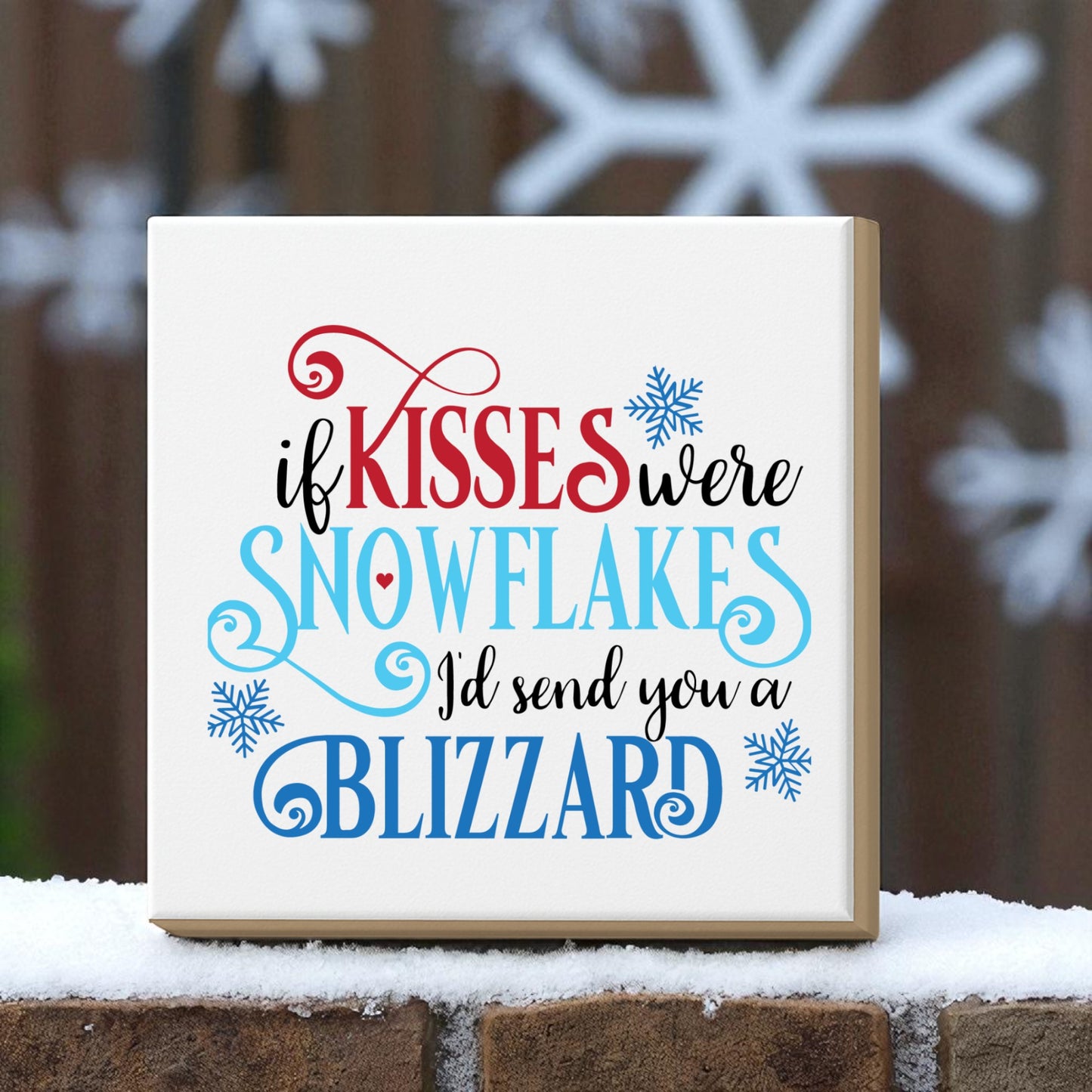 Add a touch of romance with Mirabilia Boutique's "If Kisses Were Snowflakes" winter quote wall art. This blizzard sign features red, black, and blue fonts with snowflake graphics—perfect for seasonal decor.