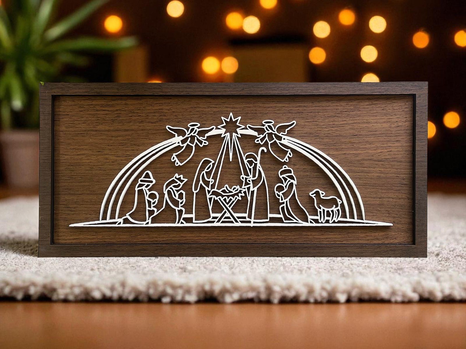 The Large Nativity Scene Sign by Mirabilia Boutique is an 18x8 handmade, laser-cut Christmas decor featuring a minimalist white outline of the holy family, wise men, shepherds, sheep, and angels under a shining star.