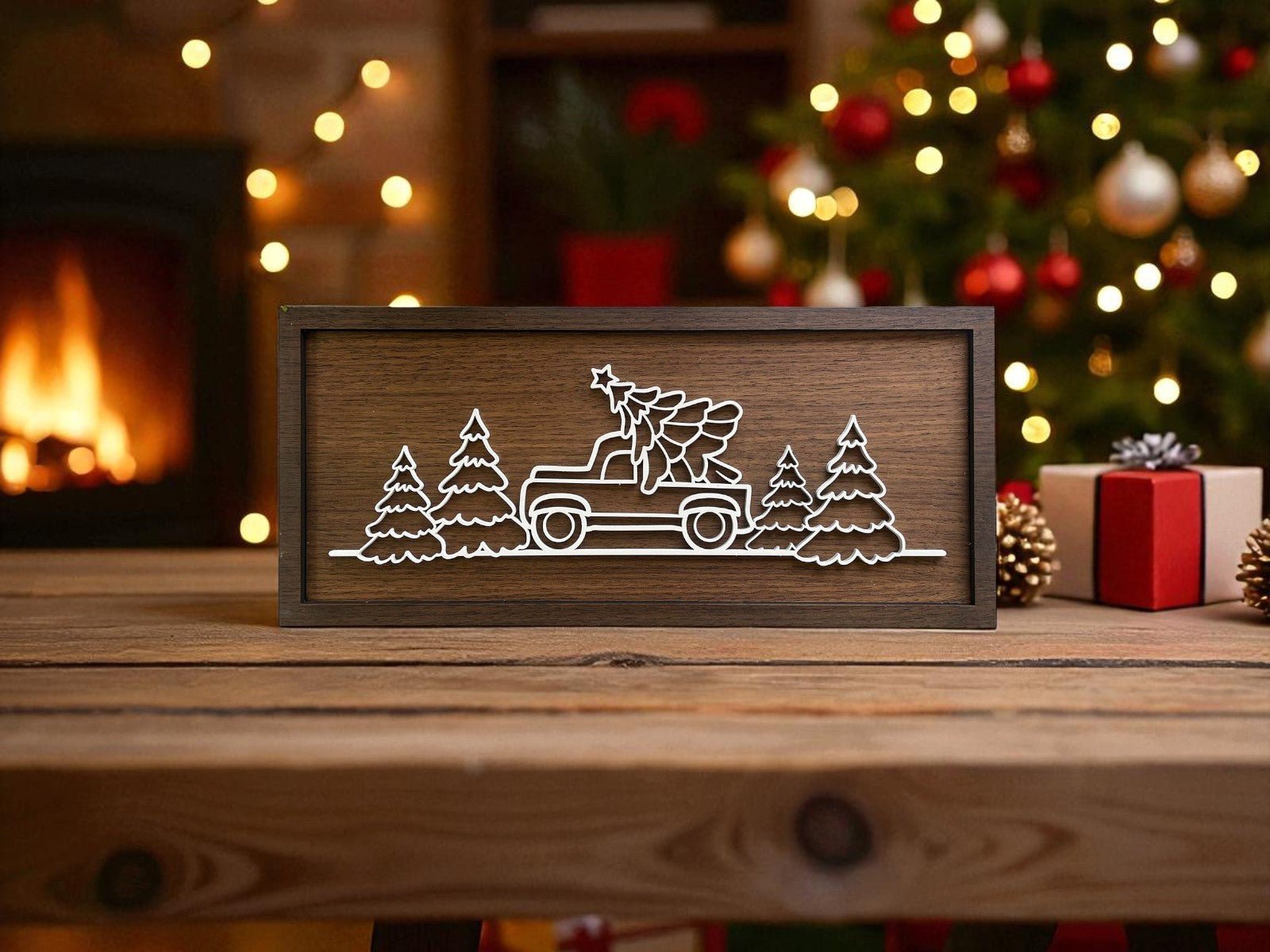 The Truck & Tree Laser Cut Christmas Sign (9x4") by Mirabilia Boutique features a rustic truck with tree design, perfect for cozy modern farmhouse decor alongside festive trees, a lit fireplace, and wrapped gifts.