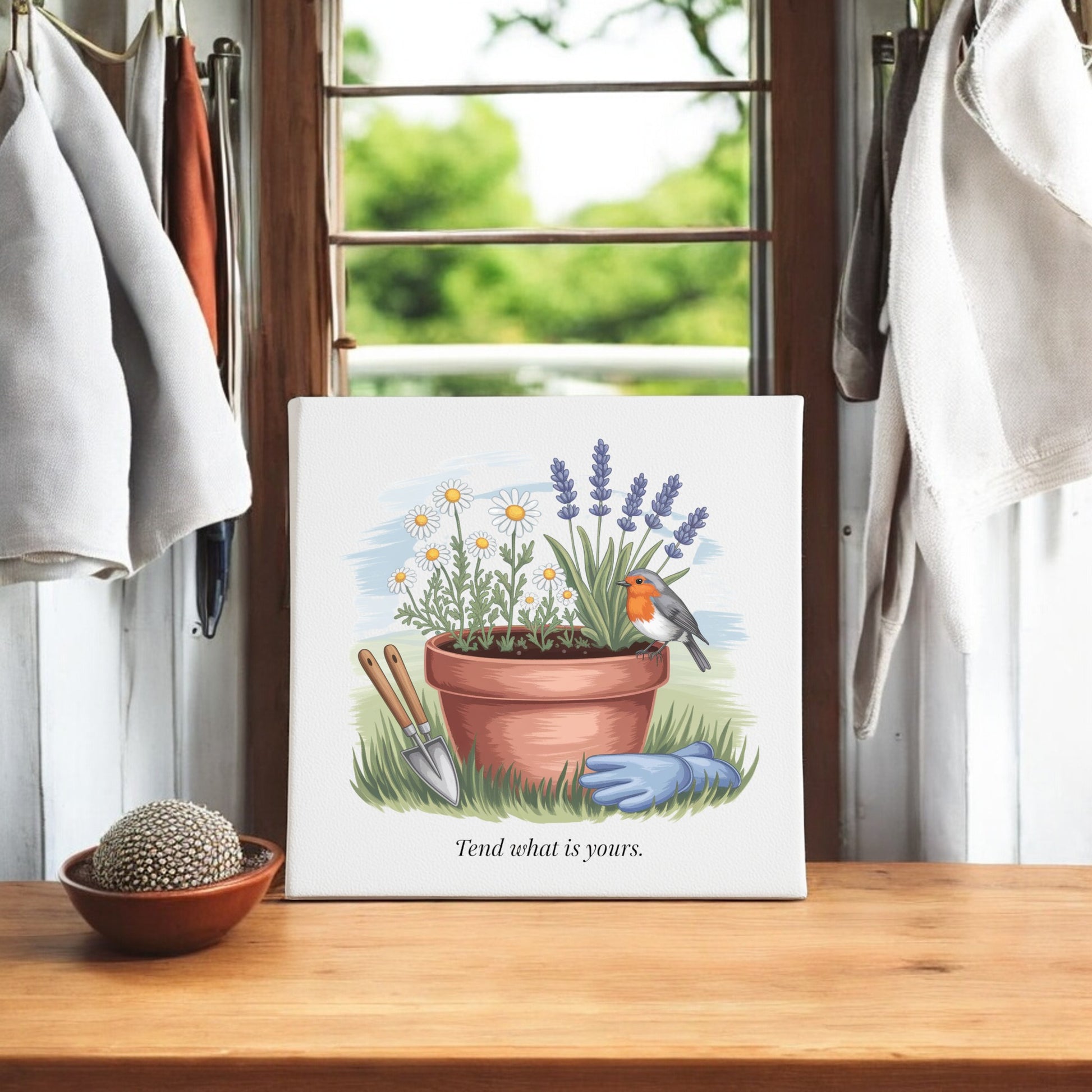 The Mirabilia Boutique "Tend What Is Yours Canvas Sign" (8x8 Garden Art) features a potted plant, garden tools, gloves, and a robin—ideal home decor or gardener gift. It reads: "Tend what is yours.