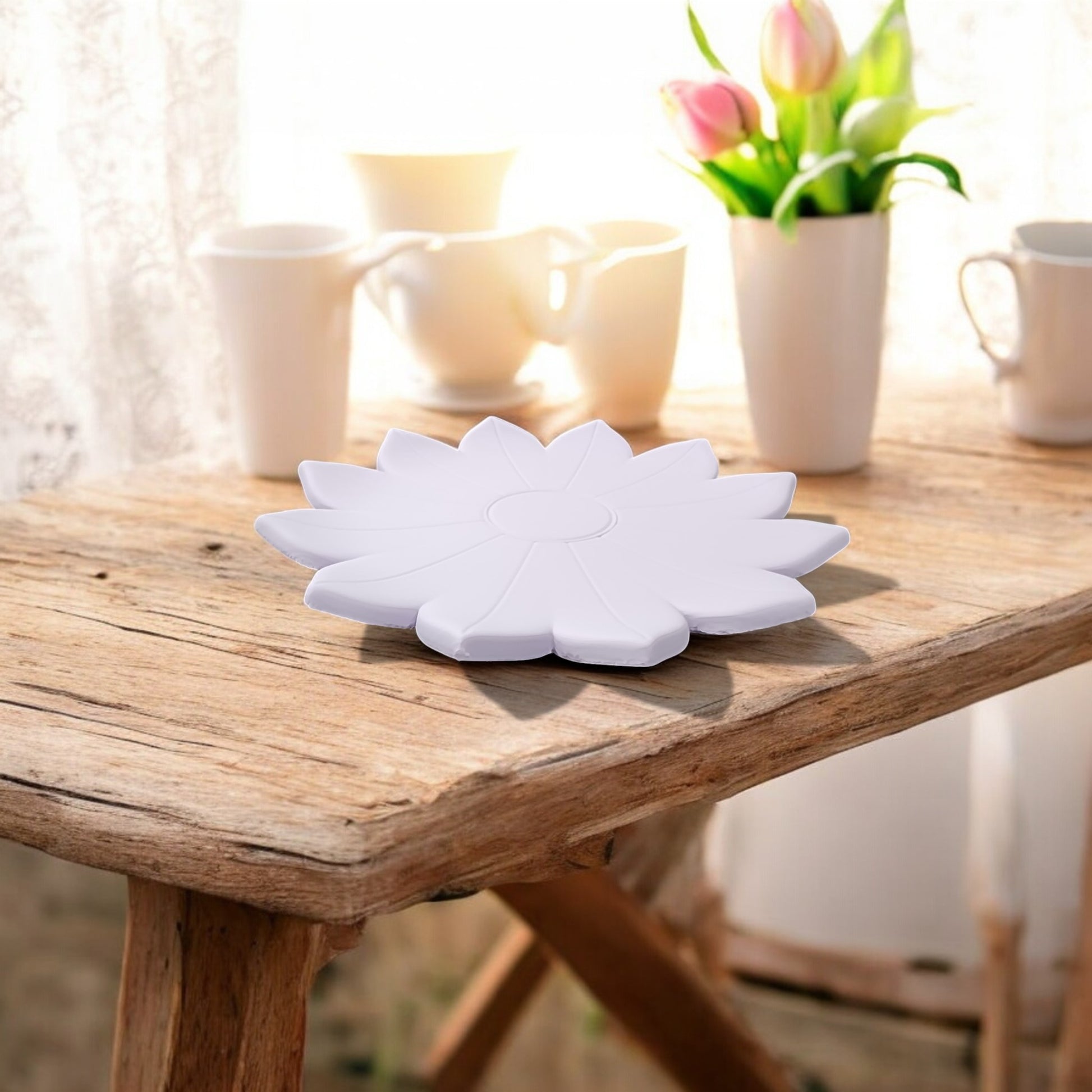 The Mirabilia Boutique Spring Bloom Tray—a delicate floral accent—rests on a rustic wooden table by a window with sheer curtains, surrounded by white cups and pink tulips as sunlight brightens the cozy space.