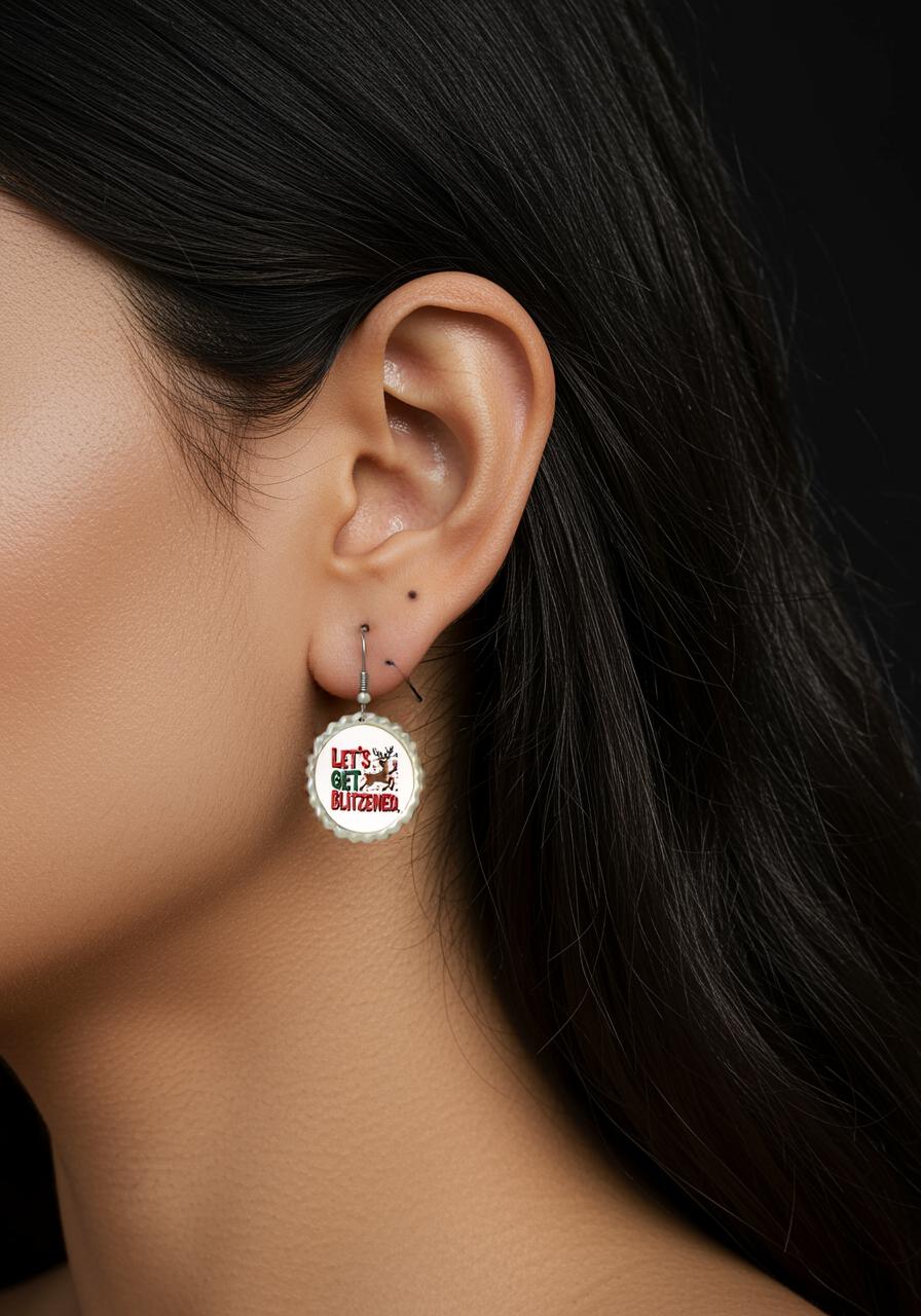 Close-up of a woman's ear wearing Mirabilia Boutique's Let's Get Blitzened | Funny Christmas Earrings with red text and a reindeer. These festive earrings add holiday cheer. Black background.