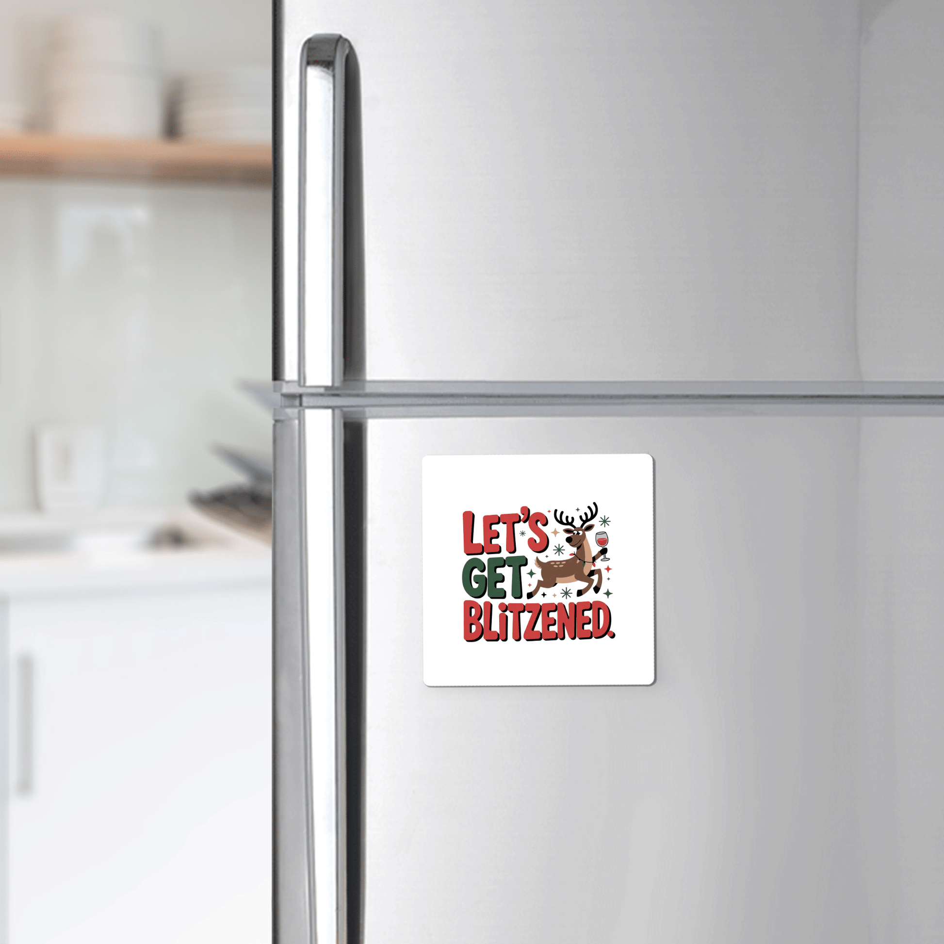 Add holiday cheer to your fridge with the Let's Get Blitzened Magnet by Mirabilia Boutique—a funny Christmas fridge decor featuring a smiling reindeer, perfect as a festive gift for wine lovers.