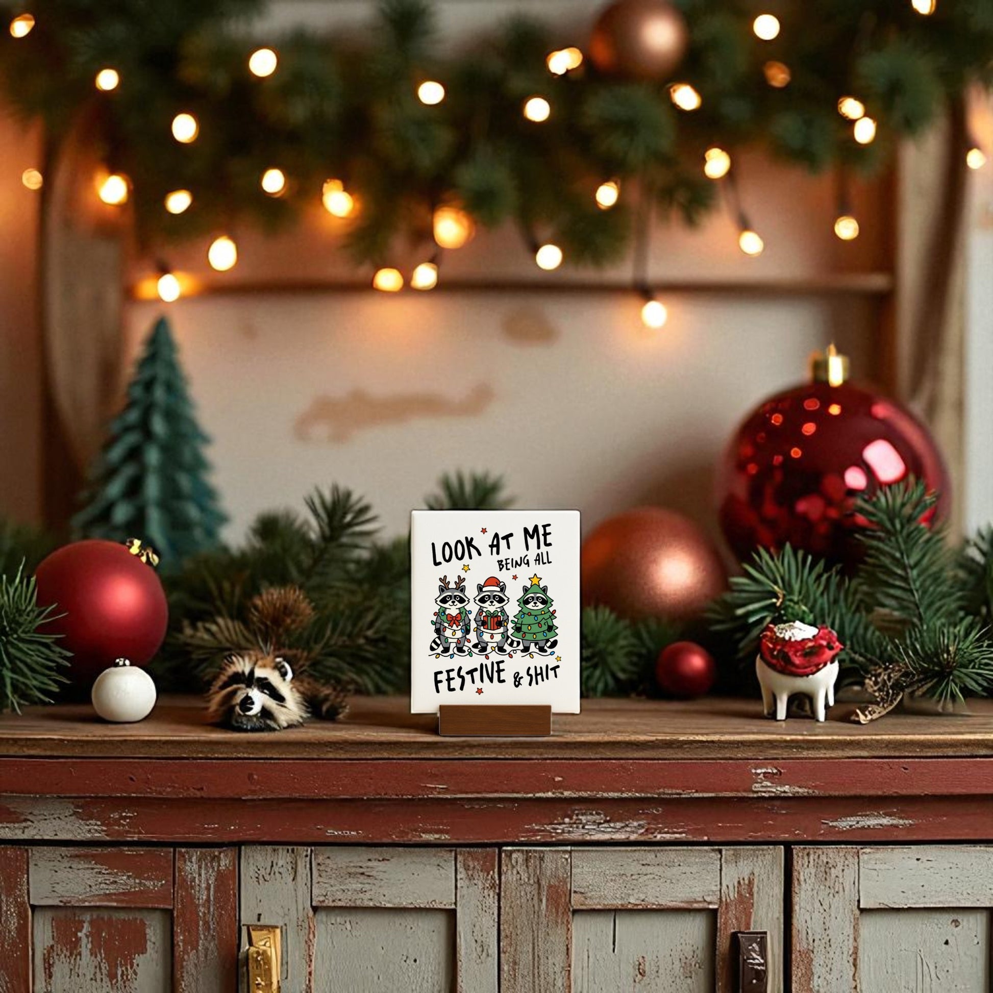 The Look at Me Being Festive Funny Christmas Raccoon Sign by Mirabilia Boutique adds playful charm to your table, making it a delightful festive decoration for any holiday gathering.