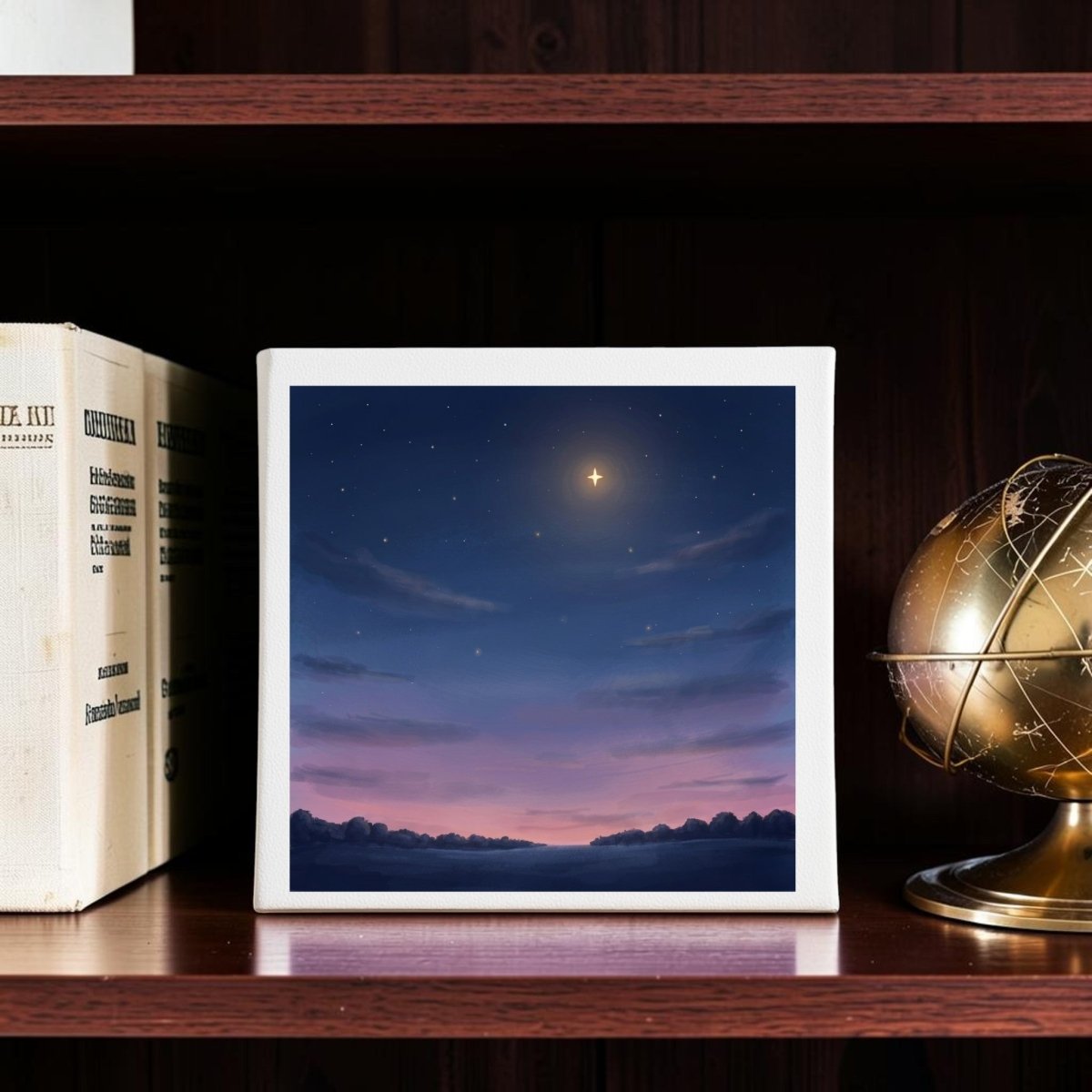 The Look Up Celestial Canvas Wall Art by Mirabilia Boutique showcases a small painting of a starry twilight sky with a bright star, pink clouds, and a dark horizon, beautifully displayed on a wooden shelf beside books and a brass globe—adding the perfect touch of twilight sky decor to your space.