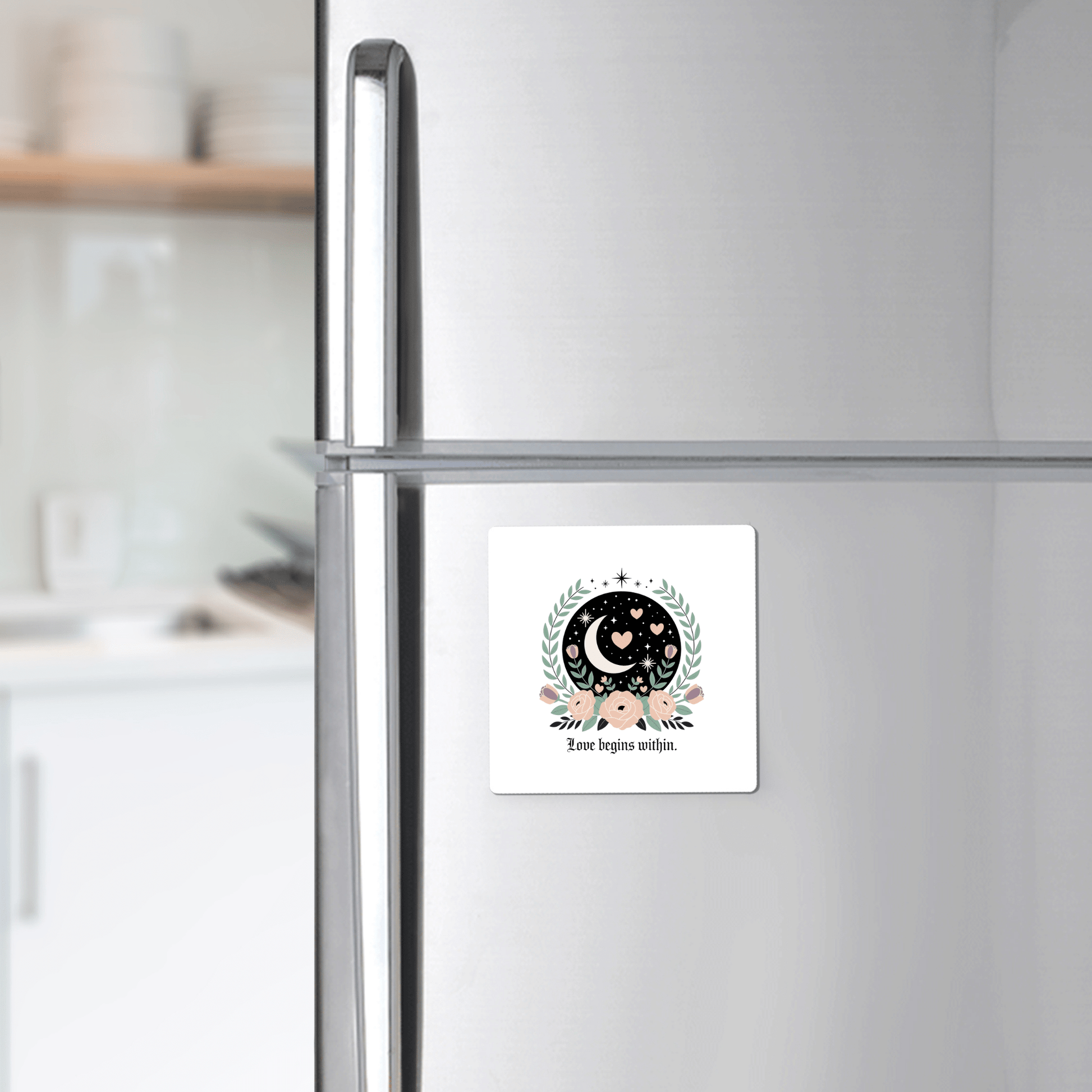 The Love Begins Within Magnet by Mirabilia Boutique, a square self-love gift with celestial and floral designs, adds inspiration to your fridge with its crescent moon, stars, and hearts, reminding you that love starts from within.