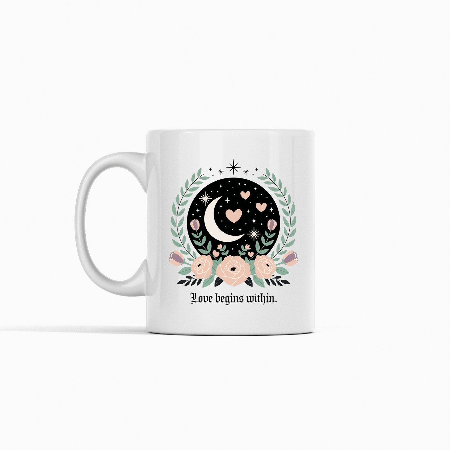 The Love Begins Within Mug from Mirabilia Boutique features a crescent moon, hearts, stars, and pink flowers with green leaves, plus the quote "Love begins within." A perfect self-love gift for any occasion. Shown on a white background.