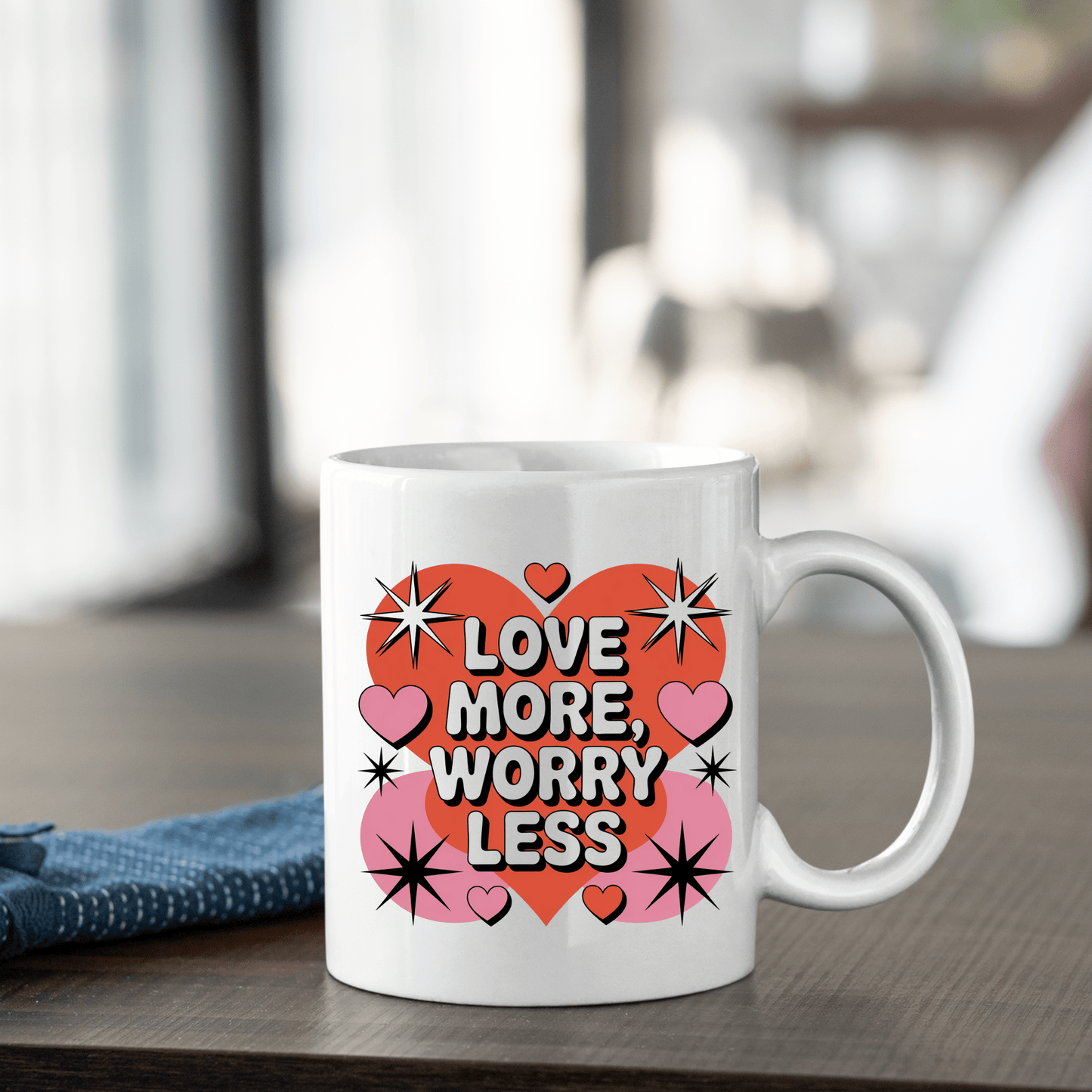The Love More Worry Less Mug by Mirabilia Boutique features a retro red heart with “Love More, Worry Less,” pink hearts, and black stars—an ideal Valentine’s Day gift from the Retro Valentine Coffee Cup collection.