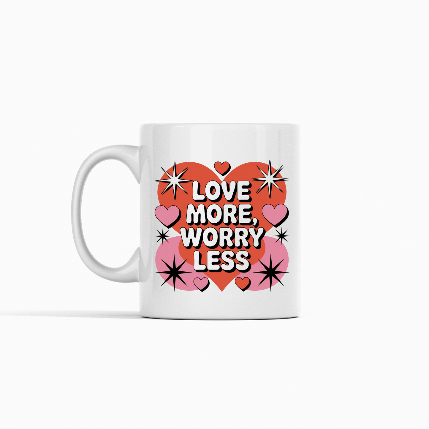 The Love More Worry Less Mug by Mirabilia Boutique is a retro Valentine coffee cup featuring a big red heart, pink hearts, and black stars—perfect for gifting and spreading joy with every sip.