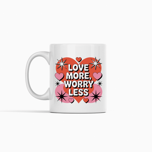 The Love More Worry Less Mug by Mirabilia Boutique is a retro Valentine coffee cup featuring a big red heart, pink hearts, and black stars—perfect for gifting and spreading joy with every sip.