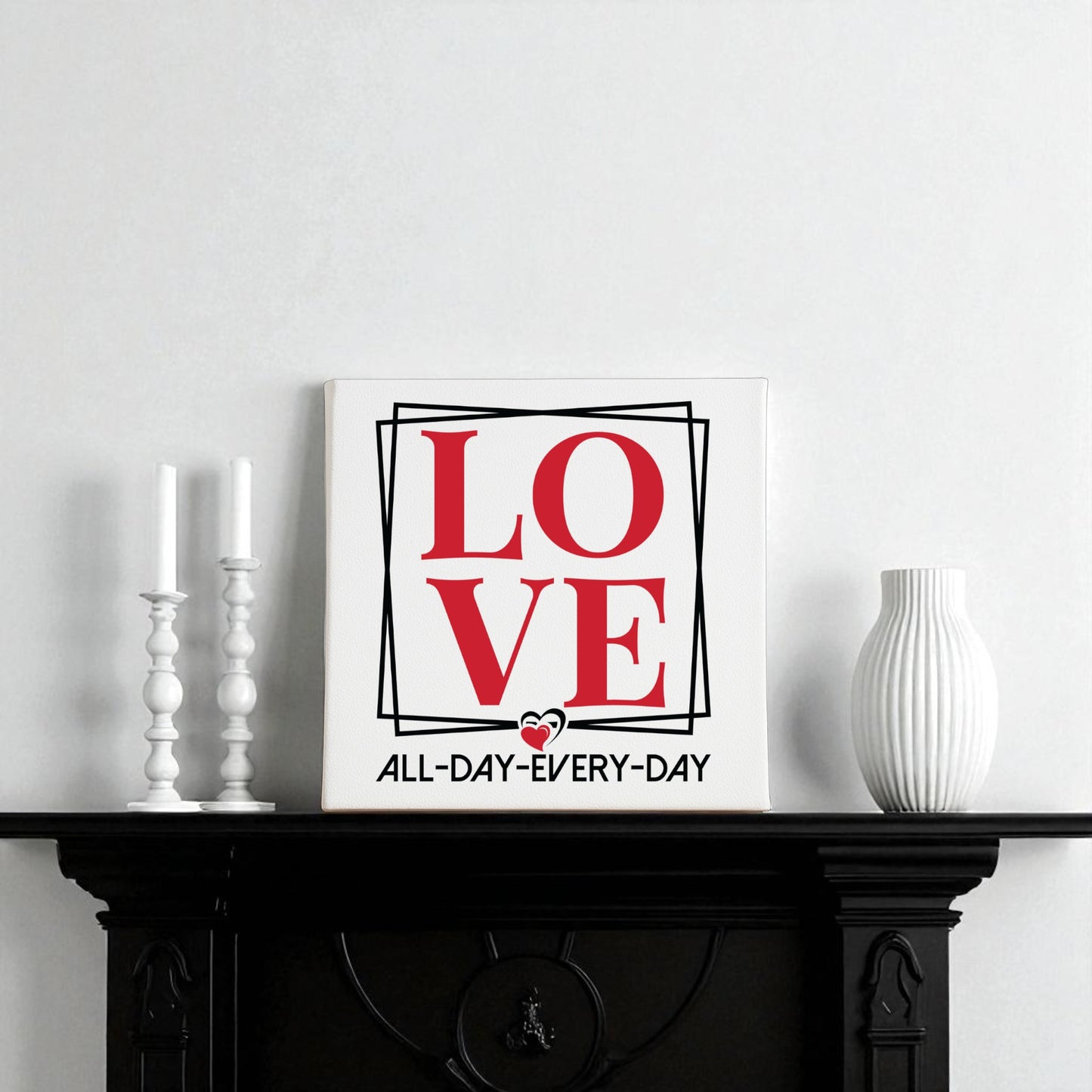 The Mirabilia Boutique Love Wall Art Print | All Day Every Day features bold red letters and modern design, perfect for any space. Stylish on a black mantel with candles and a vase, it makes a chic romantic gift and brings minimalist flair to your decor.