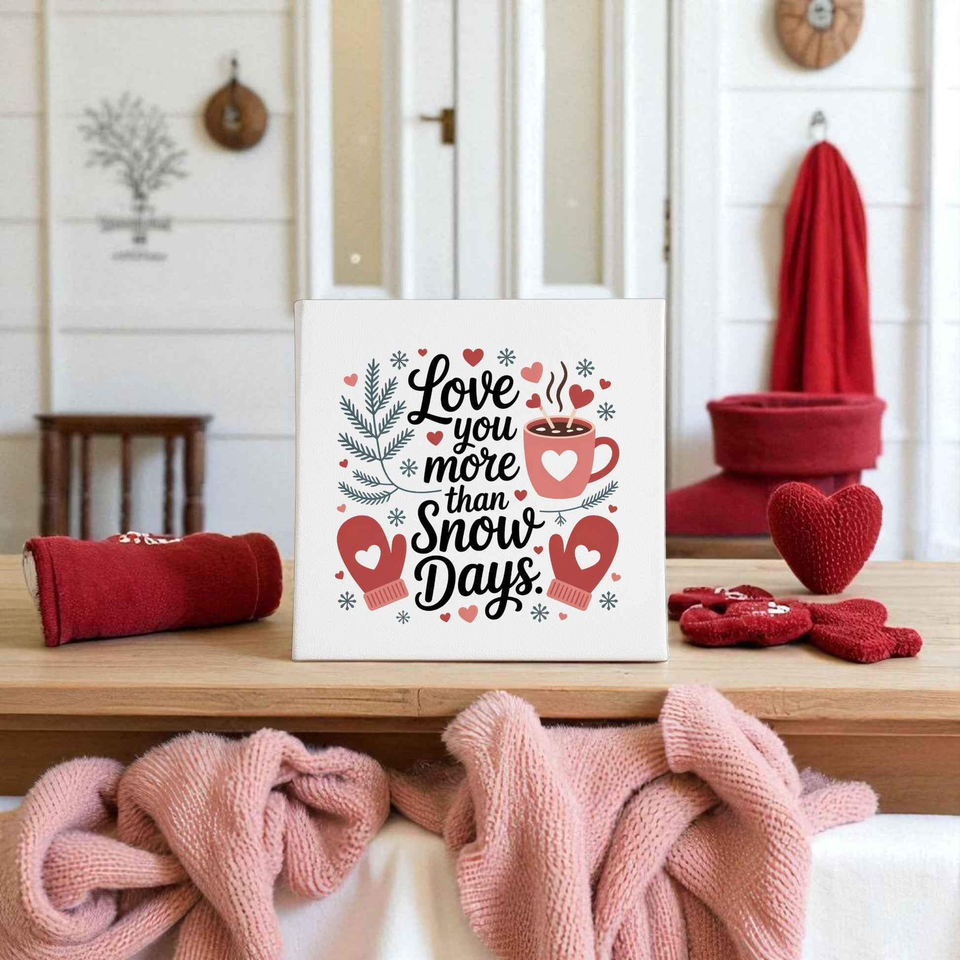 The "Love You More Than Snow Days" Print by Mirabilia Boutique is a charming winter wall art gift, ideal for romantic décor in cozy spaces, surrounded by heart decorations and festive mugs.