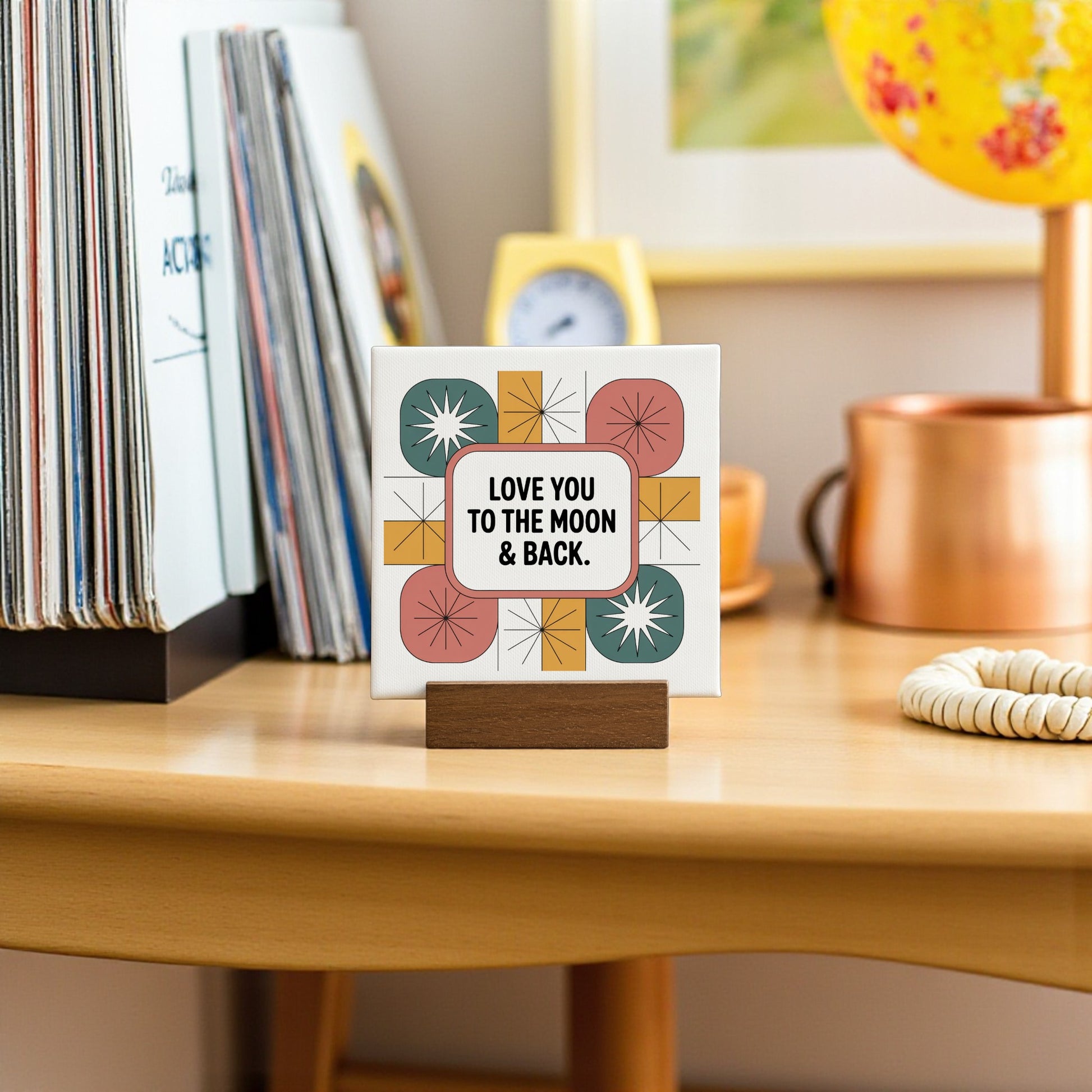 The Mirabilia Boutique "Love You to the Moon & Back" 4x4 Mini Canvas Retro Sign features colorful geometric patterns and makes a perfect love gift or retro home decor accent for desks, bookshelves, or nightstands.