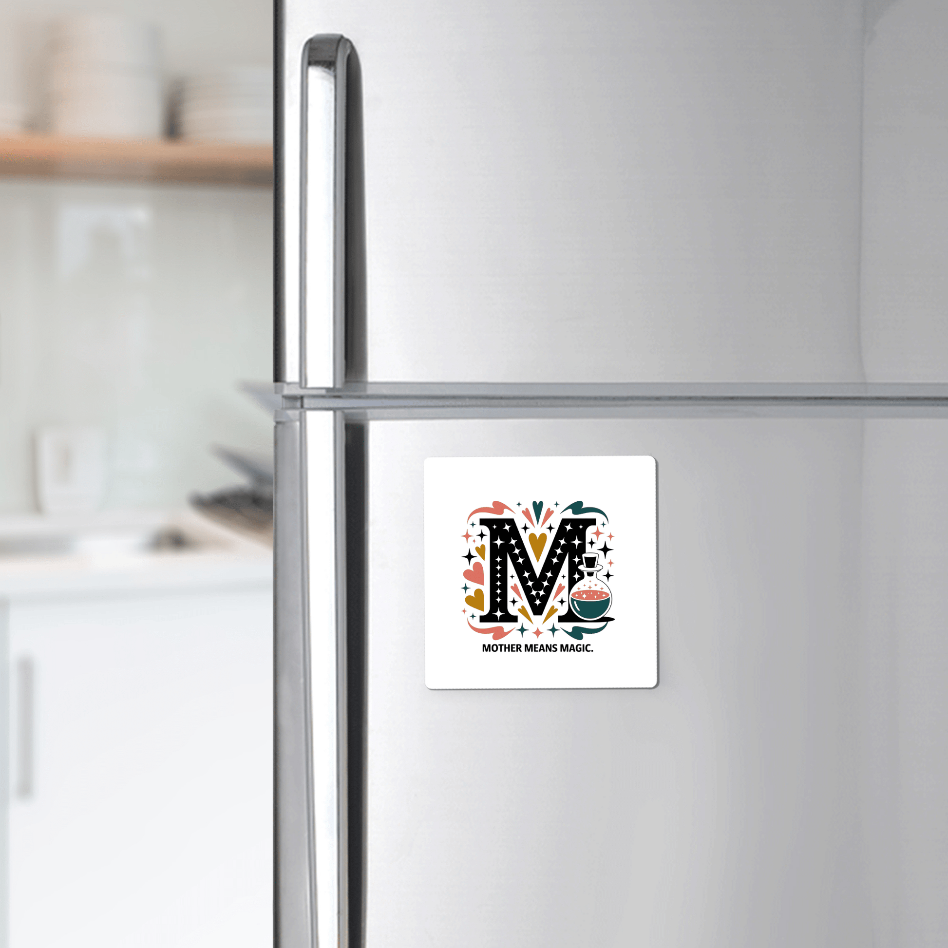 The Mother Means Magic Magnet from Mirabilia Boutique features a colorful "M" and sweet message—adding whimsy to your fridge. A charming Mother's Day gift for your magical mom!.