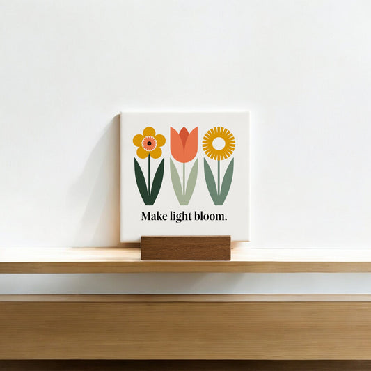 The Make Light Bloom Mini Canvas Sign with Wood Base by Mirabilia Boutique features simple floral art and the phrase “Make light bloom.”—an ideal daily affirmation or charming decor for small spaces.