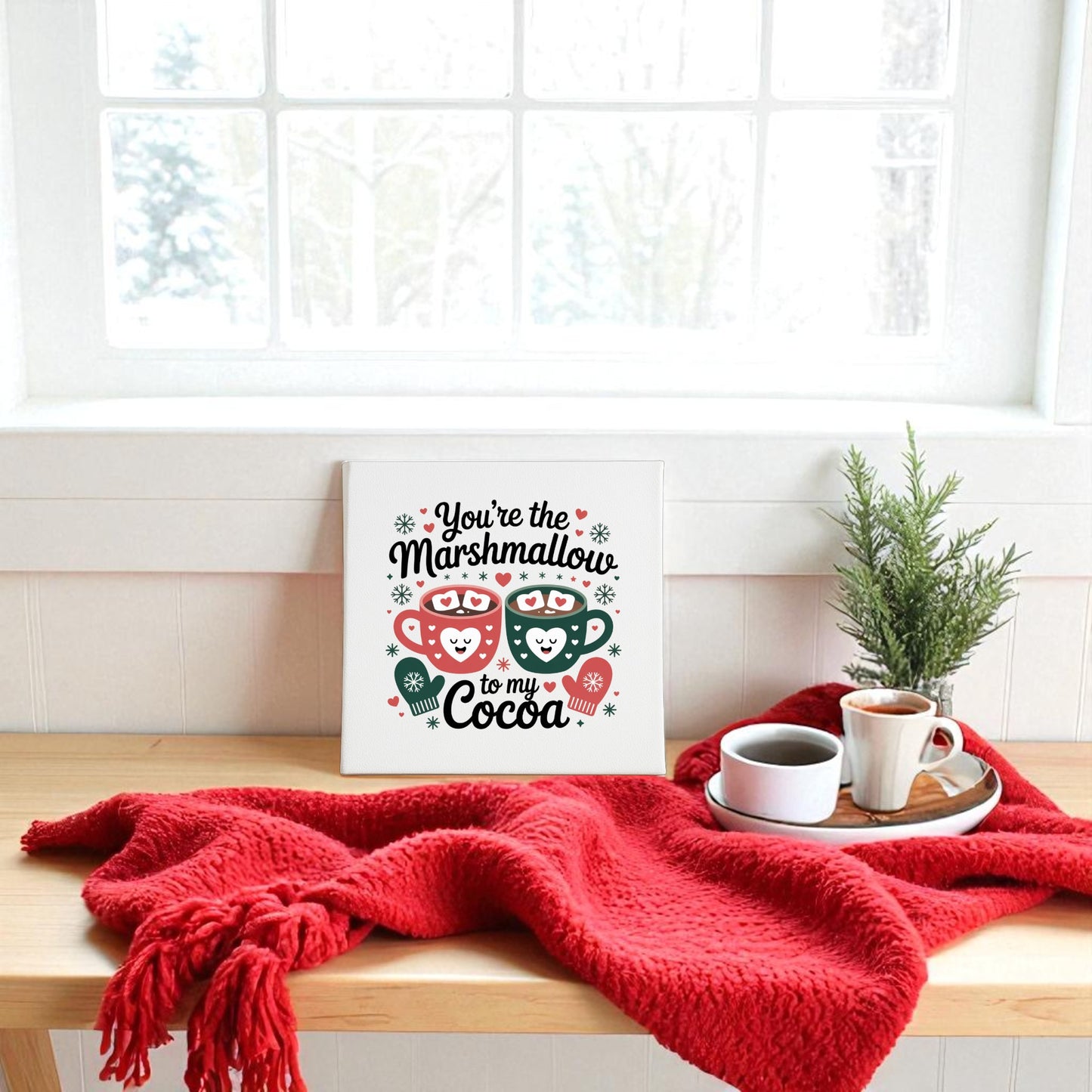 Create a cozy winter vibe with the Marshmallow to My Cocoa Sign by Mirabilia Boutique. This 8x8 canvas art pairs perfectly with a red blanket, coffee, and snowy trees for a charming seasonal touch.