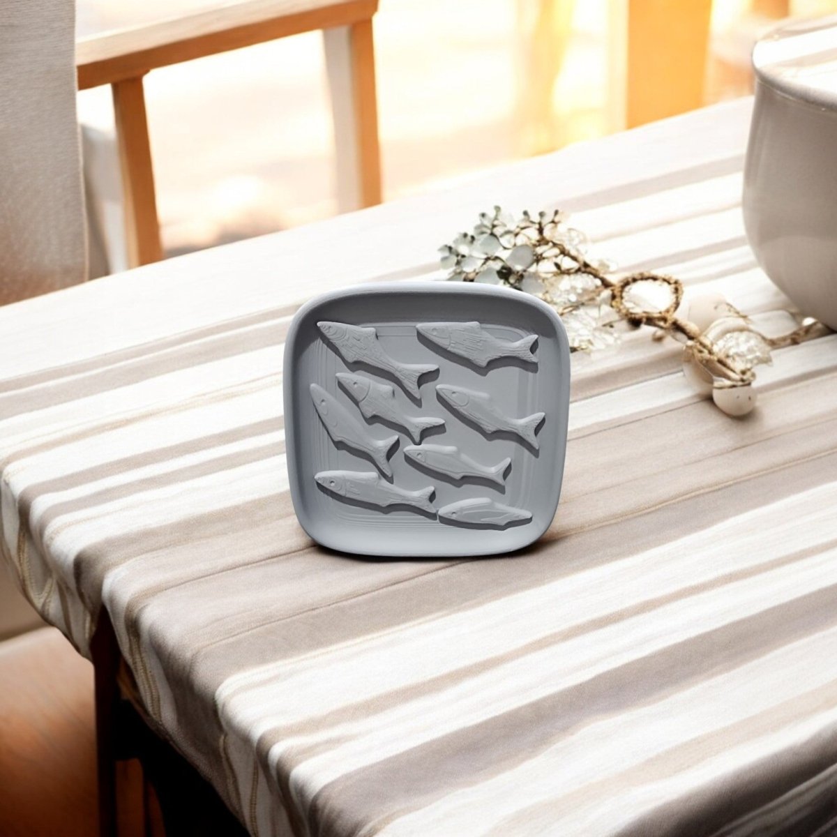 The Coastal Fish Decorative Tray by Mirabilia Boutique features fish-shaped compartments and adds sculptural coastal texture to your kitchen, bringing ocean-inspired decor to any space.