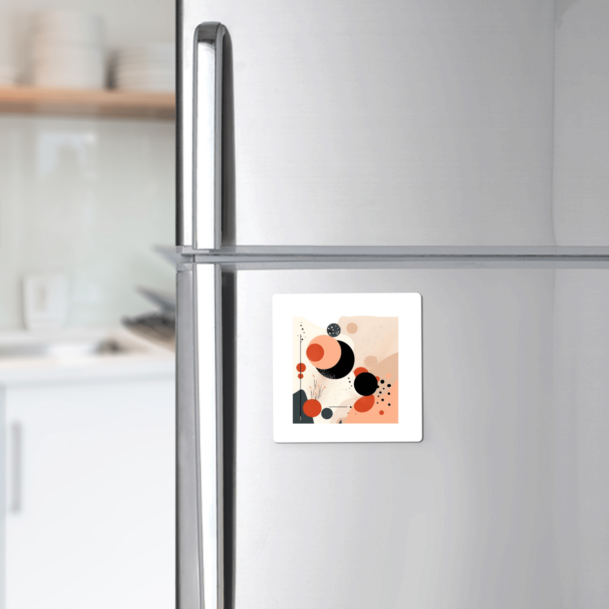 The Solar Bloom Mid Century Modern Magnet by Mirabilia Boutique features bold geometric shapes in black, red, and peach, adding a striking modern accent to a stainless steel fridge in any contemporary kitchen.