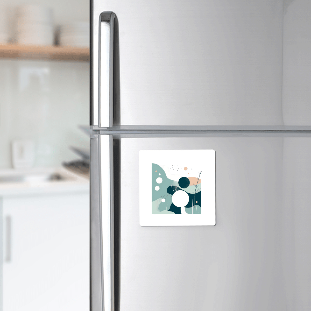 The Quiet Tides Mid Century Modern Magnet by Mirabilia Boutique, featuring blue, green, and white abstract art, adds a stylish accent to your modern kitchen when displayed on your silver refrigerator.
