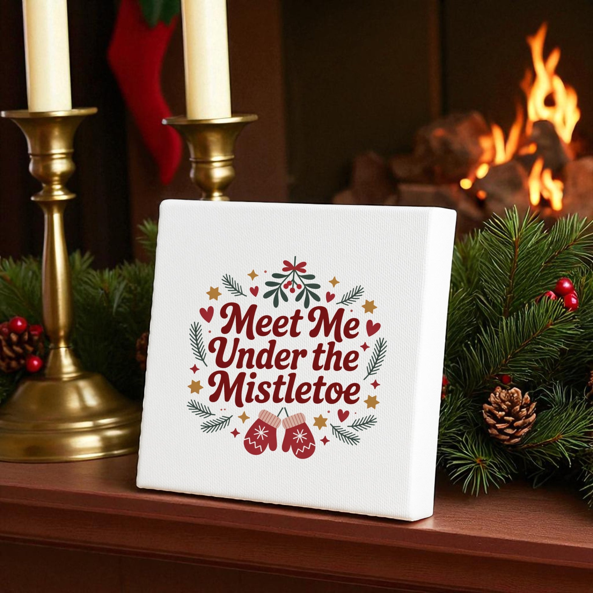 The Mirabilia Boutique "Meet Me Under the Mistletoe" 8x8 canvas sign adds festive charm to your mantel, surrounded by pine branches and candles—perfect holiday decor for a cozy Christmas gathering.