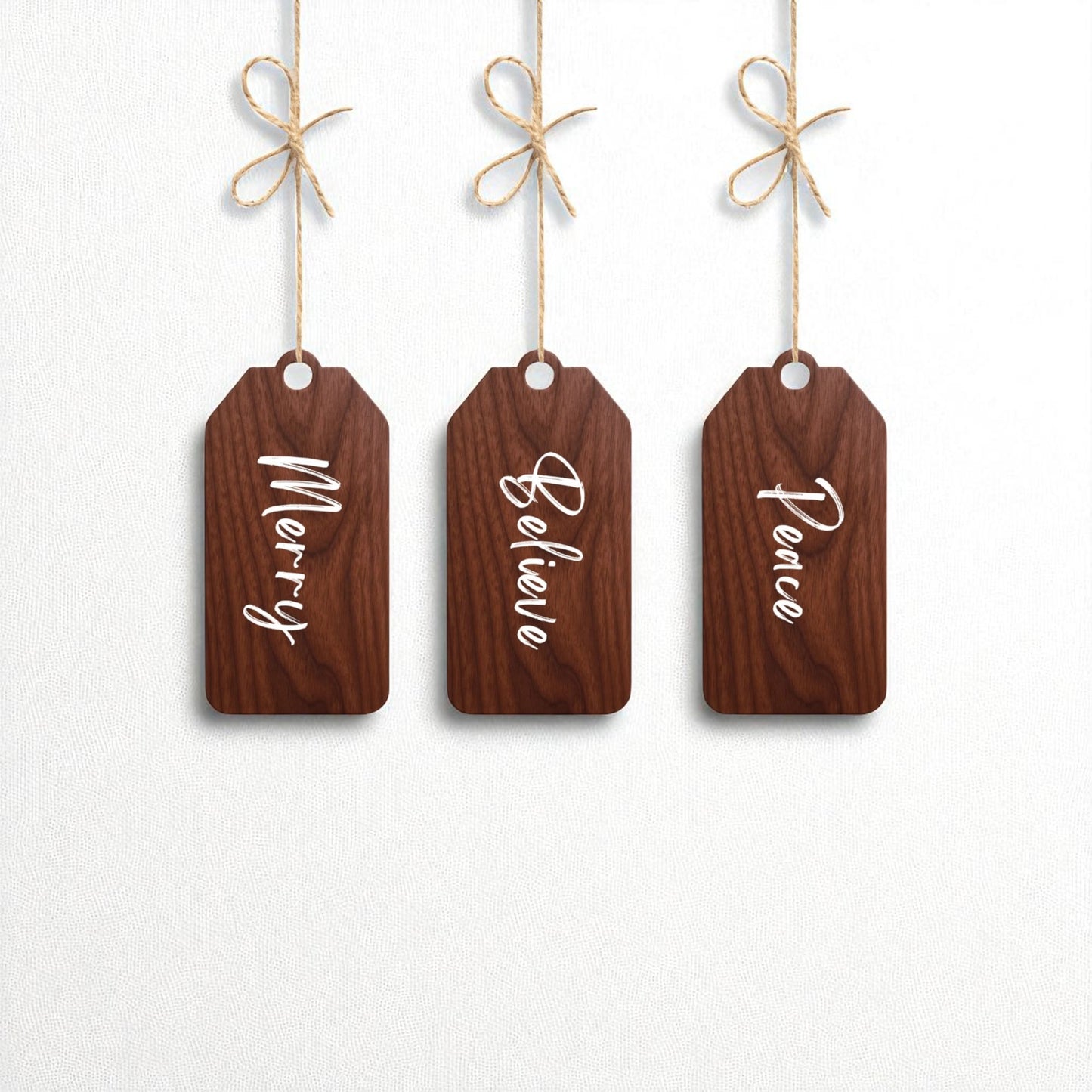 The Mirabilia Boutique Merry Believe Peace Tags | 5x2 Wooden Christmas Decor Set features three rustic wood tags with "Merry," "Believe," and "Peace" in white script—perfect as ornaments or festive holiday accents.