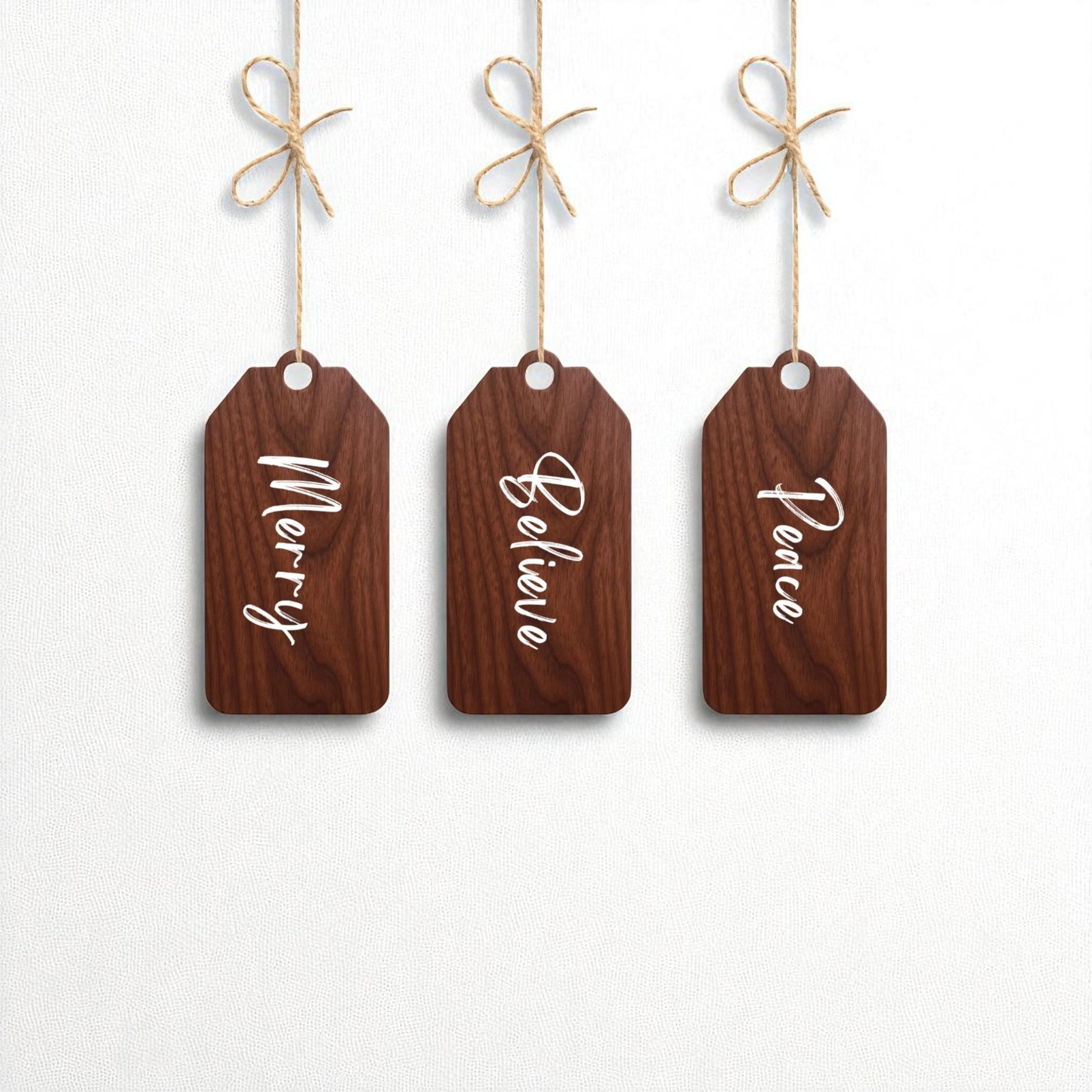 The Mirabilia Boutique Merry Believe Peace Tags | 5x2 Wooden Christmas Decor Set features three rustic wood tags with "Merry," "Believe," and "Peace" in white script—perfect as ornaments or festive holiday accents.