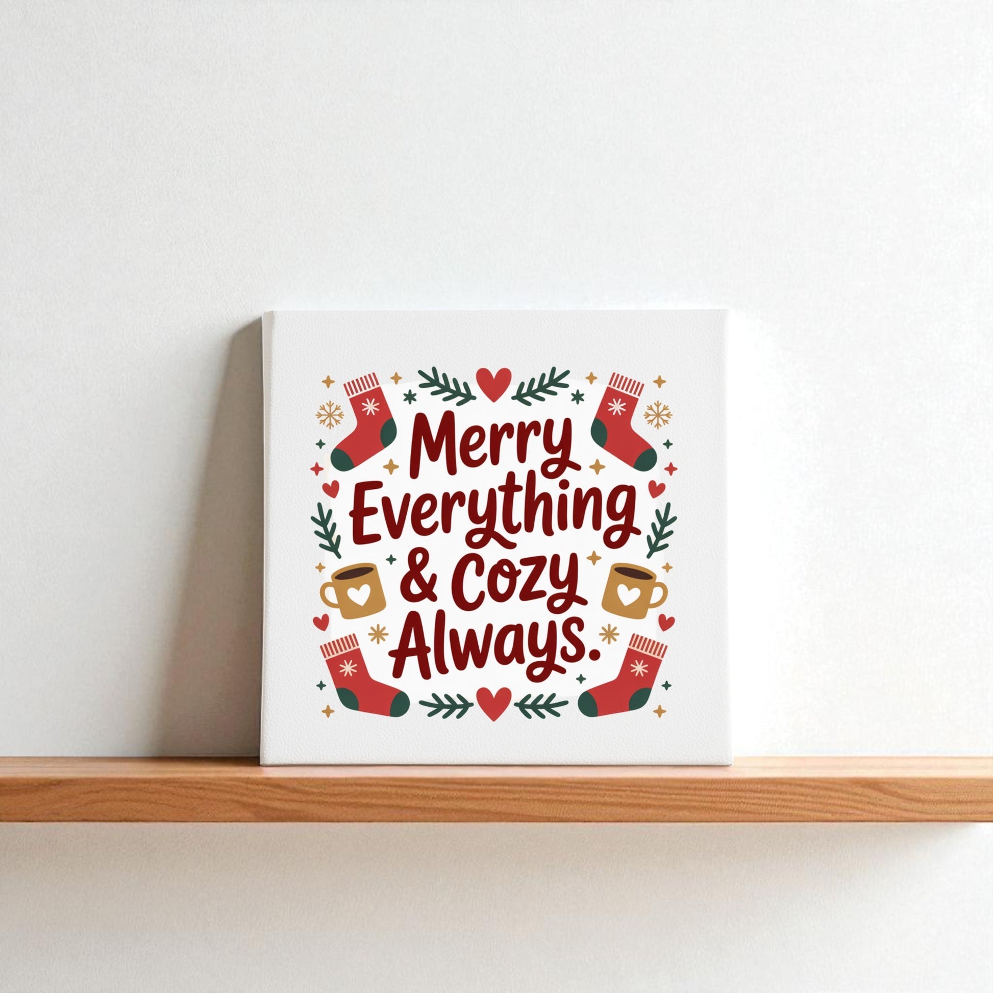 The Merry Everything & Cozy Always Canvas (8x8) by Mirabilia Boutique features festive text with stockings, mugs, stars, and greenery—perfect as a cozy gift or holiday wall art for any space.
