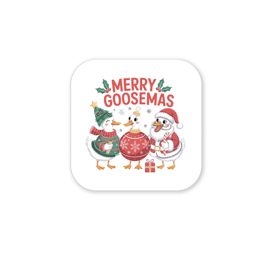 The Merry Goosemas Magnet by Mirabilia Boutique features three festive geese in Christmas outfits under "Merry Goosemas," with snowflakes, holly, and a gift—perfect funny Christmas goose decor for your fridge!.