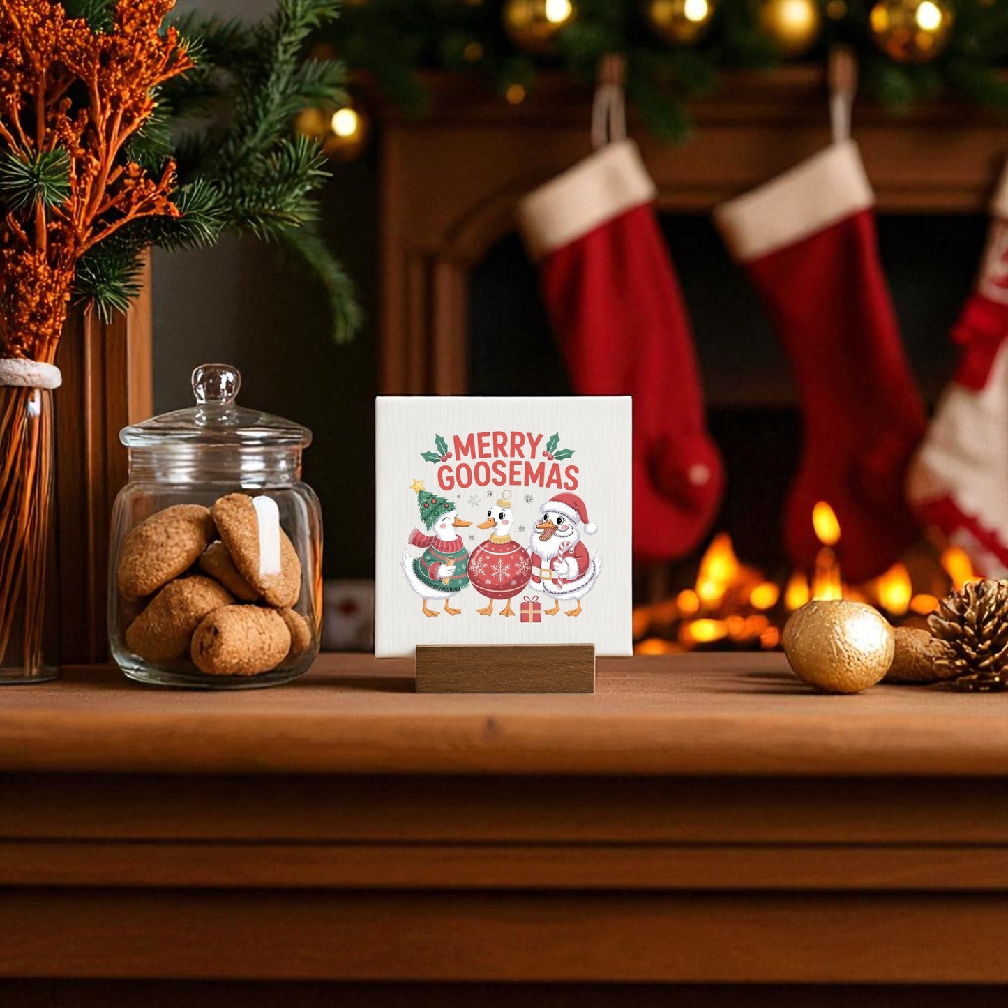 The Merry Goosemas Mini Sign by Mirabilia Boutique, a funny holiday goose decor, sits on a wooden mantle with cookies, ornaments, and quirky holiday touches—perfect for adding cheer to your festive scene or gifting to someone unique.