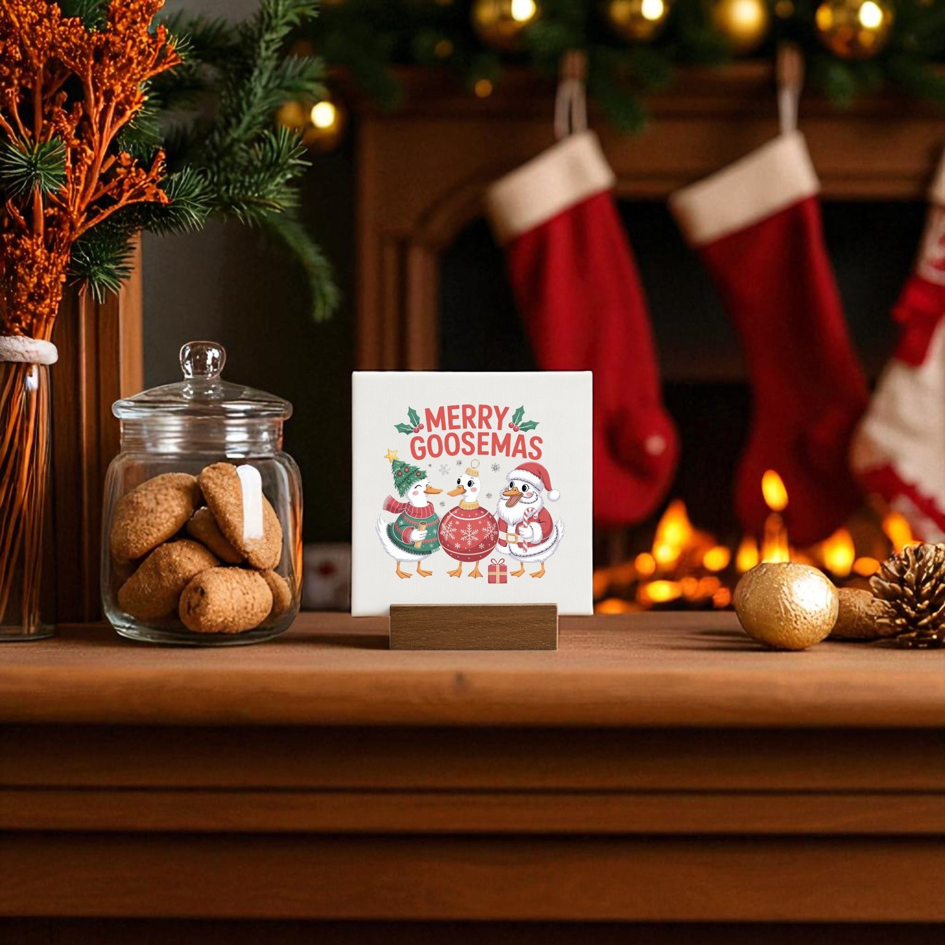 The Merry Goosemas Mini Sign by Mirabilia Boutique, a funny holiday goose decor, sits on a wooden mantle with cookies, ornaments, and quirky holiday touches—perfect for adding cheer to your festive scene or gifting to someone unique.