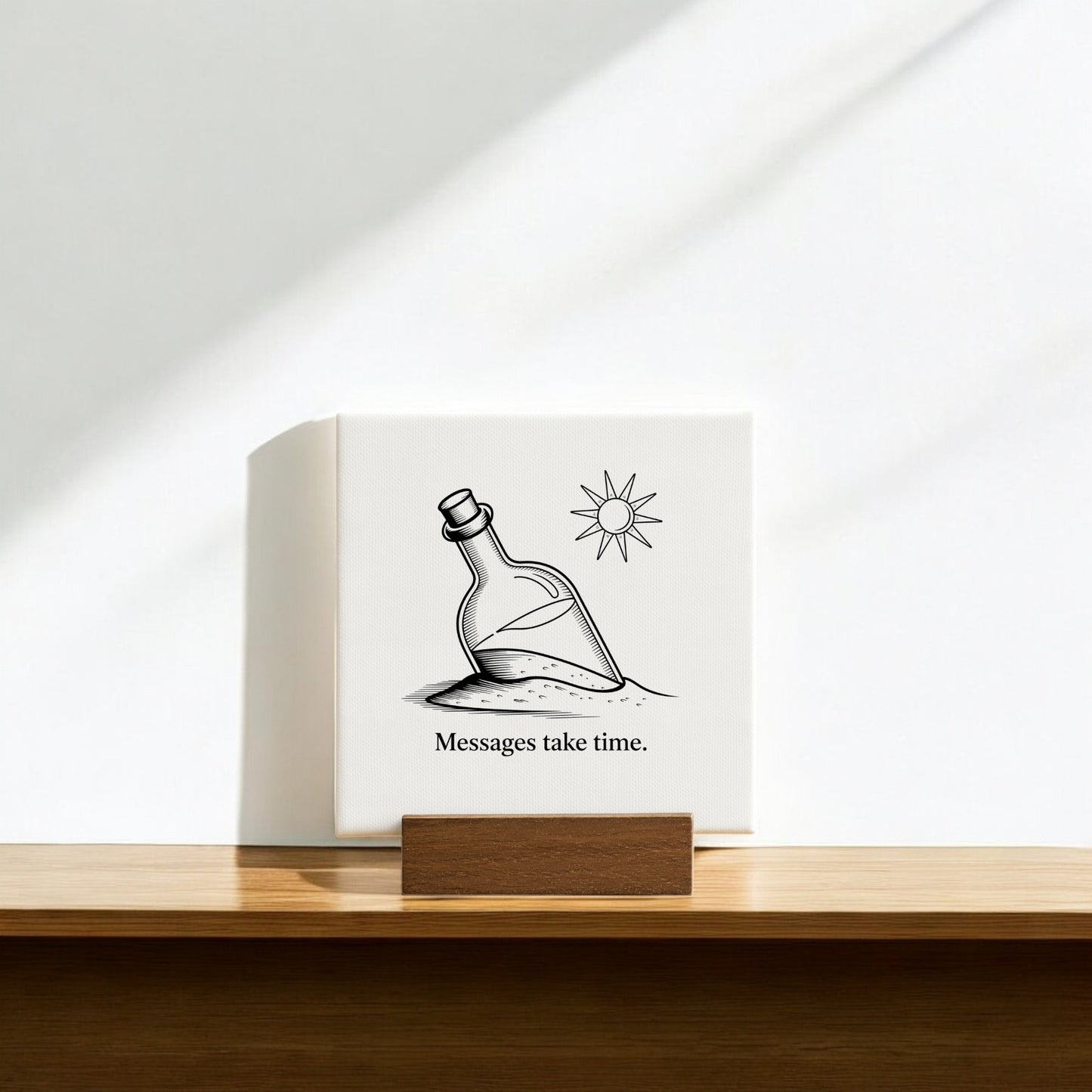 The Mirabilia Boutique Messages Take Time Mini Canvas – Desk Art with Wood Stand features a bottle in sand under the sun and the words "Messages take time," creating an inspirational decor piece for your desk.