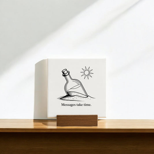 The Mirabilia Boutique Messages Take Time Mini Canvas – Desk Art with Wood Stand features a bottle in sand under the sun and the words "Messages take time," creating an inspirational decor piece for your desk.