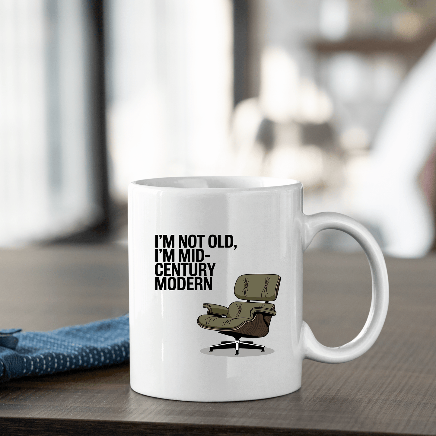The Mirabilia Boutique Mid-Century Modern Mug with Retro Humor features “I'M NOT OLD, I'M MID-CENTURY MODERN” and a lounge chair illustration—perfect for vintage design lovers.