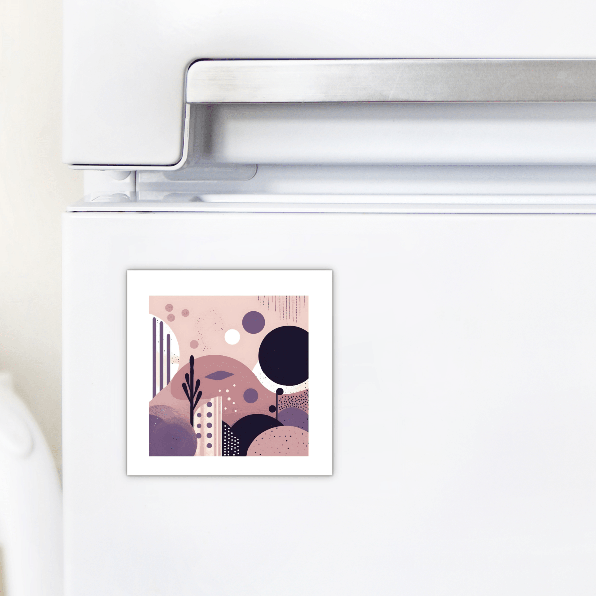 A white refrigerator with the Mirabilia Boutique Purple Dusk Mid Century Modern Magnet, a small square decor piece featuring purple, pink, and black geometric patterns for a stylish accent.