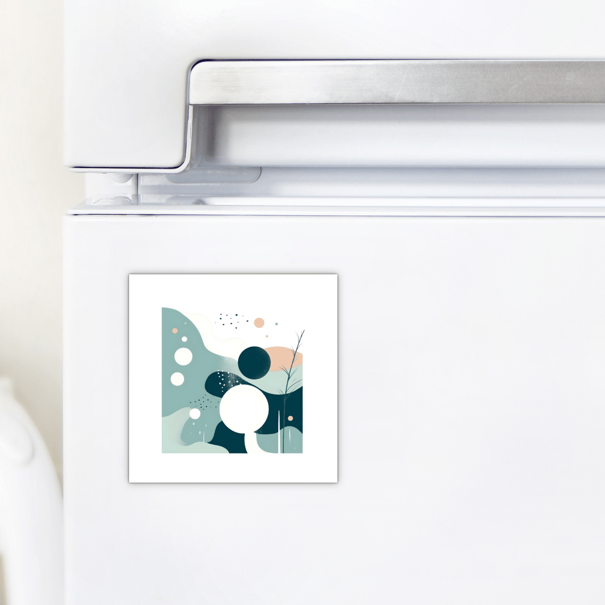 A white refrigerator displays the Mirabilia Boutique Quiet Tides Mid Century Modern Magnet, adorned with teal, ocean blue, and white circles and organic shapes accented by minimal line details.
