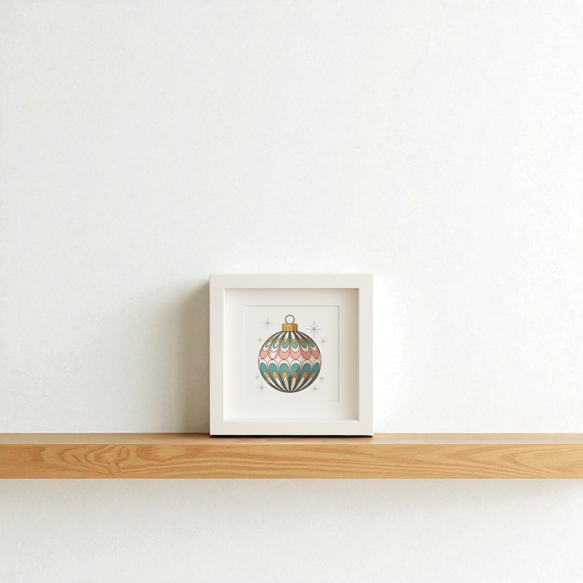 The Mirabilia Boutique Mid-Century Round Ornament Art | Retro Holiday Shadowbox features a vintage-style ornament with green, pink, and gold star patterns—perfect for mid-century modern holiday décor on your shelf or wall.