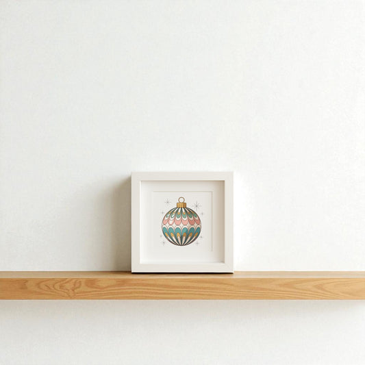 The Mirabilia Boutique Mid-Century Round Ornament Art | Retro Holiday Shadowbox features a vintage-style ornament with green, pink, and gold star patterns—perfect for mid-century modern holiday décor on your shelf or wall.