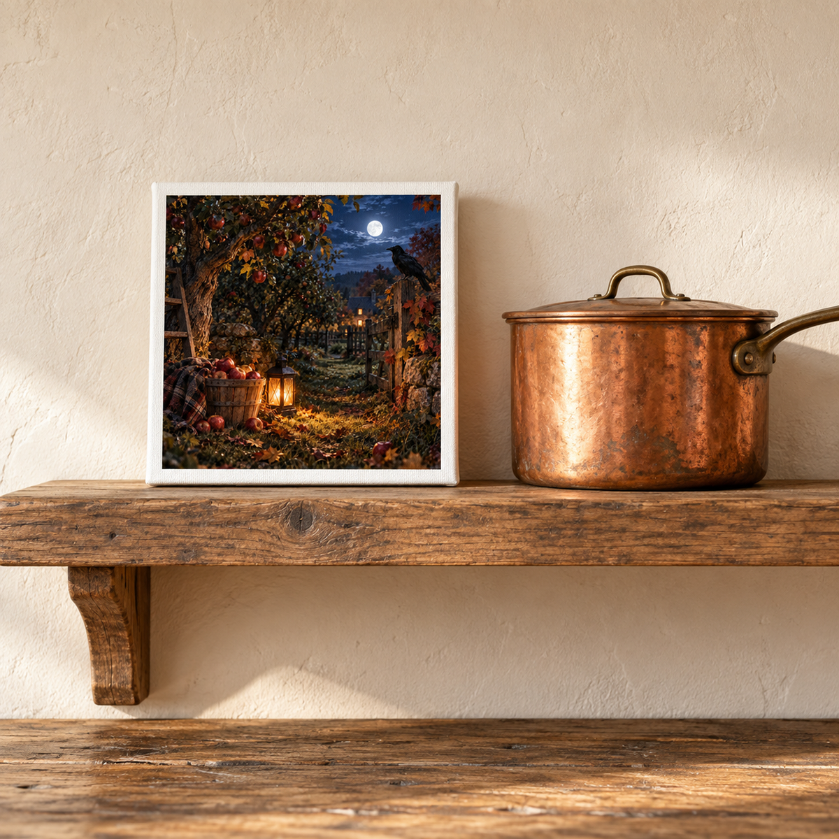 The Midnight Orchard Canvas | Autumn Raven Art by Mirabilia Boutique sits on a rustic shelf by a copper pot, its apple orchard and full moon scene enhanced by the textured wall—perfect autumn landscape wall art.