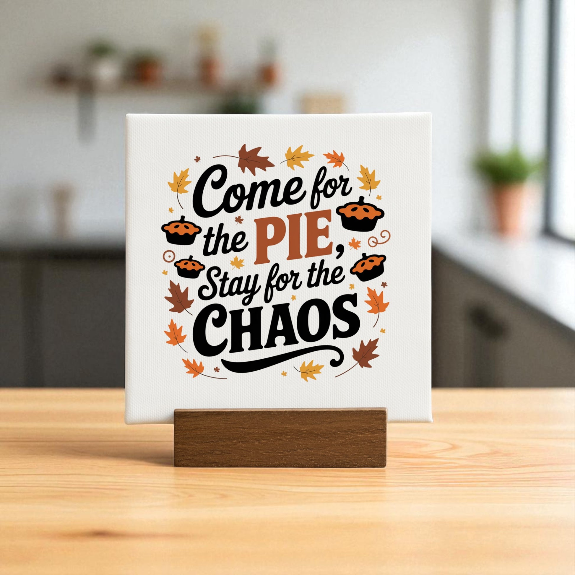 The Pie & Chaos Funny Fall Decor mini sign by Mirabilia Boutique features "Come for the pie, stay for the chaos" on a wooden stand with fall leaves—perfect as Thanksgiving decor or a charming autumn gift.