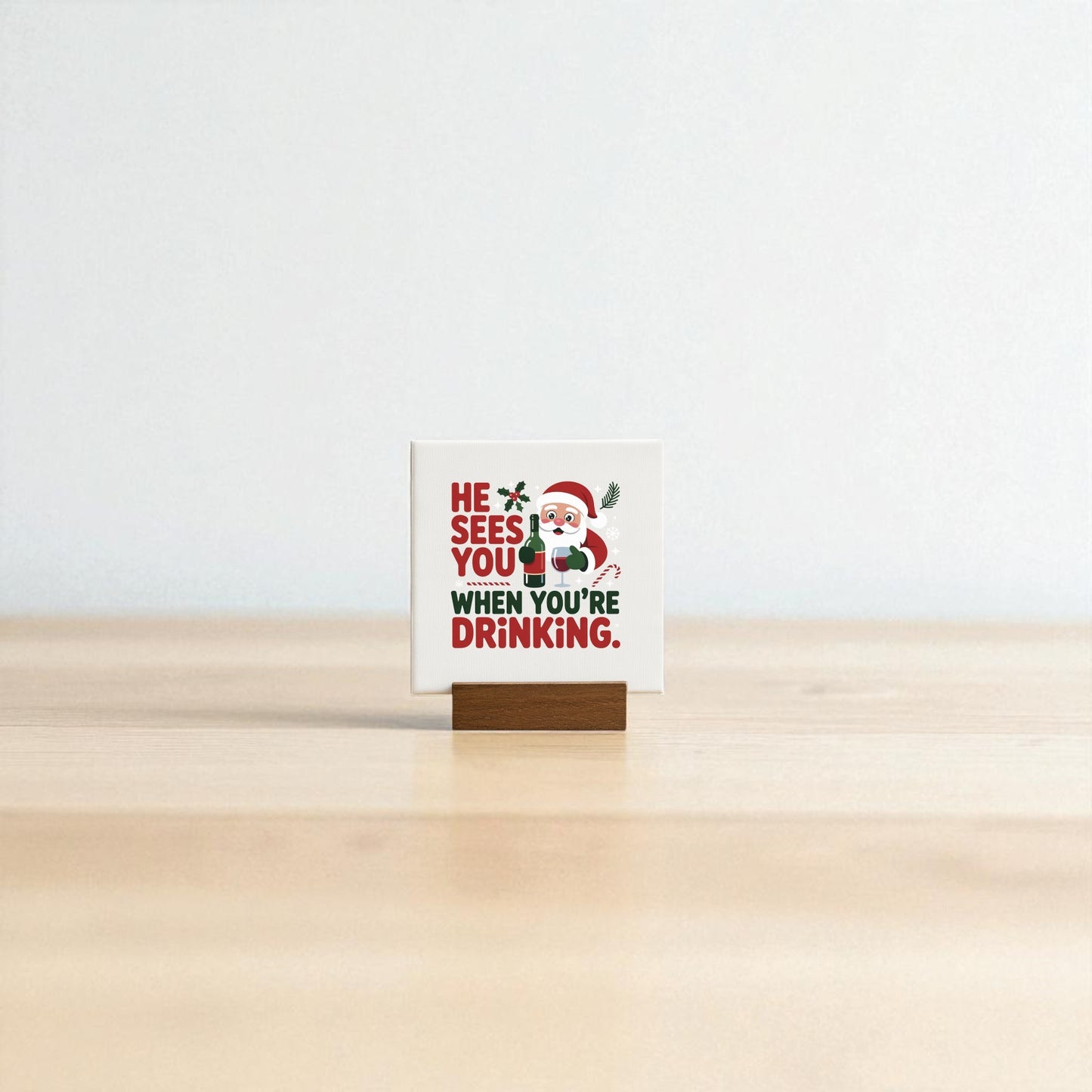 The "He Sees You When You’re Drinking" Funny Mini Christmas Sign by Mirabilia Boutique features Santa and witty text on a wooden holder—a playful holiday décor piece for your bar cart or a fun gift for wine lovers.